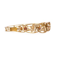 Pair of Art Nouveau Gold, Pearl and Ruby Openwork Floral Motif Bracelets