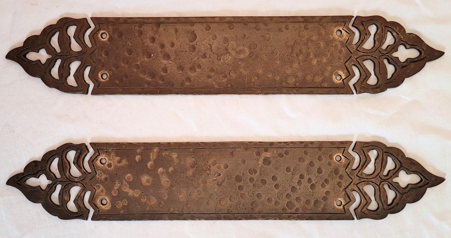 Presenting a gorgeous and unique pair of art nouveau hand beaten bronze door push plates.

Each being 13.5 inches long.

Probably made in the US circa 1910 and most definitely influenced by the English New Lynn School of Arts and Crafts Era