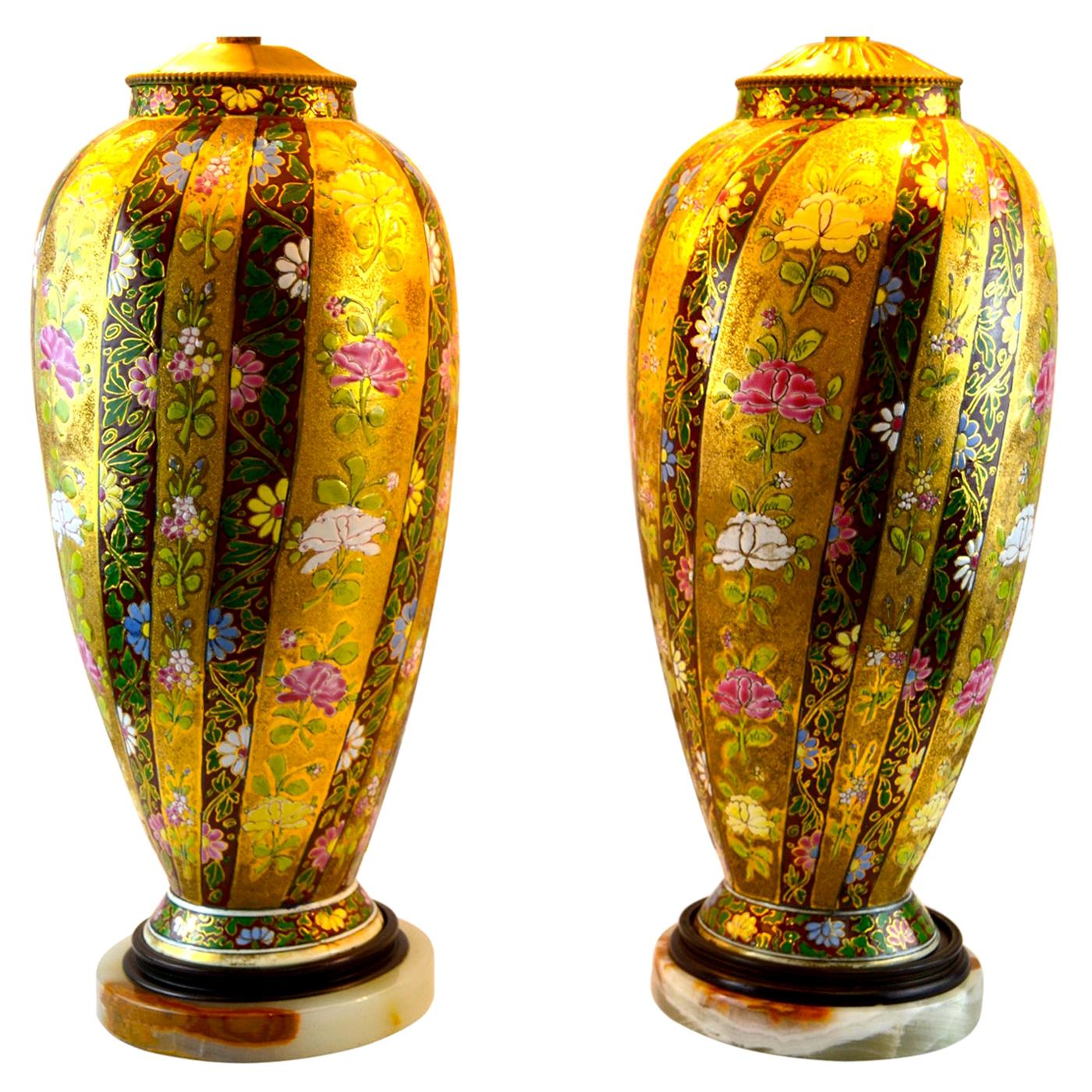 A pair of Art Nouveau porcelain vases by the Fischer Hungarian Porcelain Factory from Budapest Hungary that have been turned into lamps. The vases feature a stripe design of various colors painted with brightly colored enamel flowers on a matte gold