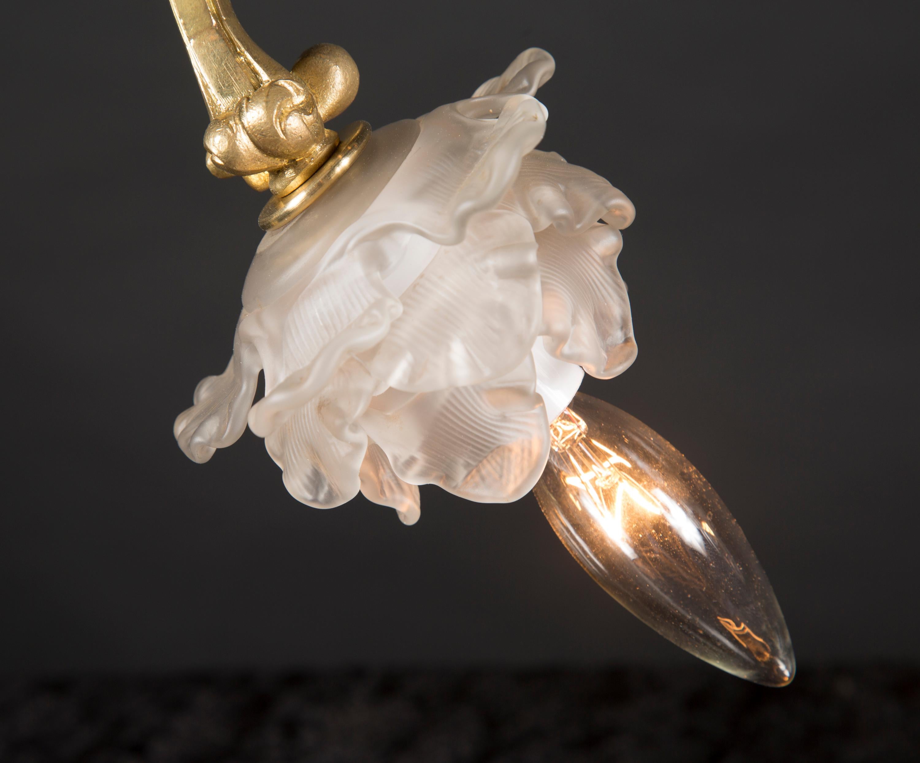 These elegant art nouveau single light lamps come directly from France and date back to the late 19th century. Their shape is magnificent, mirroring the curious lines of nature, and they feature delicate acanthus leaves along the steam with a