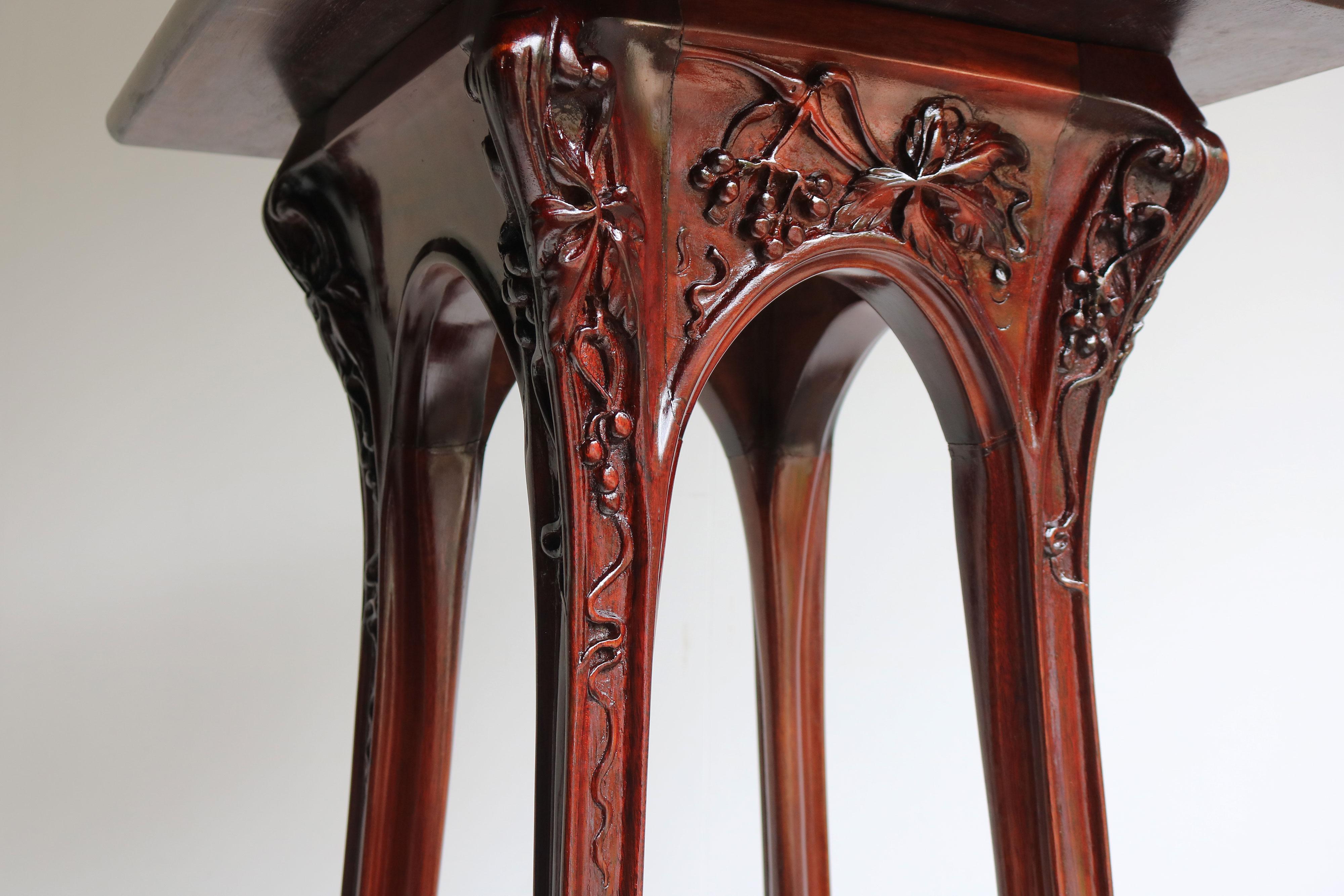 Exquisite pair of stylized Art Nouveau plant stands / pedestals by Louis Majorelle designed in 1907 with carved ''Vigne Vierge'' decorations. 
Each pedestal has 3 tiers and the top tiers rotate 360 degrees. Exquisite crafted and fully hand carved