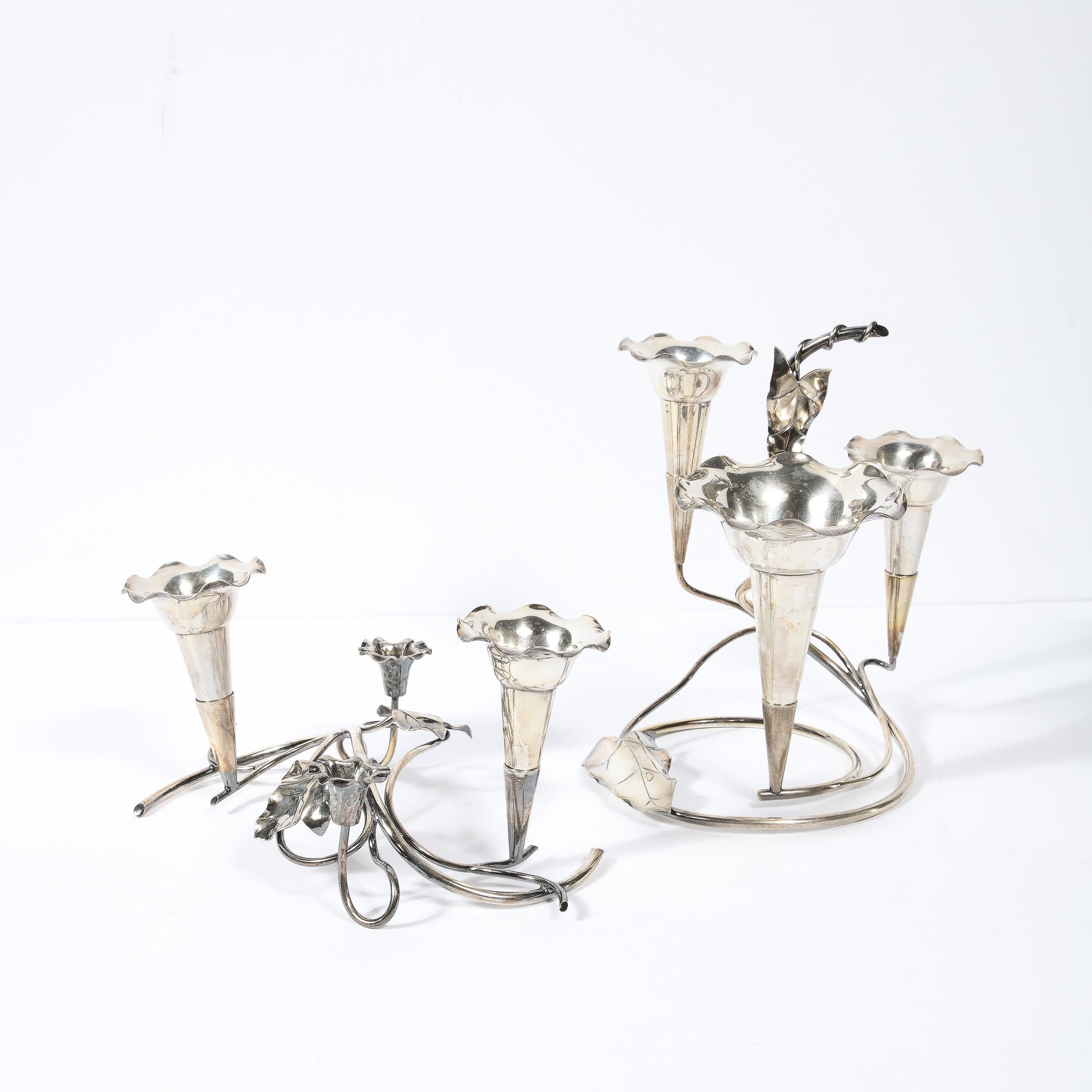 This stunning and sculptural pair of silver-plate Art Nouveau candleholders were realized in the United States circa 1915. They feature a base composed of swirling curvilinear stylized vines (a leitmotif throughout Art Nouveau design) that support