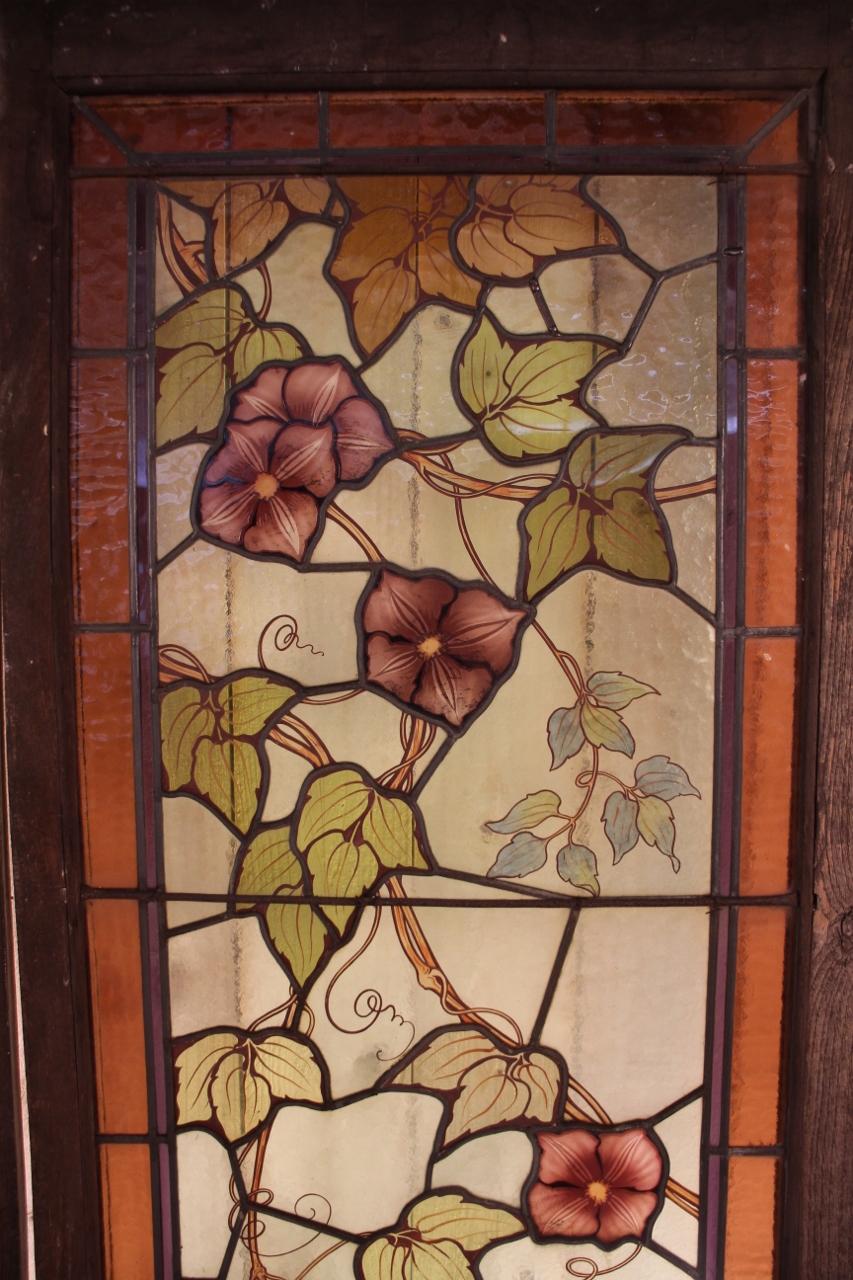 Pair of Art Nouveau period stained glass with flowers signed by Jacques Gruber the stained glass windows are in very good condition, in a wooden frame, as is Measure with the window frame: 191 cm high by 63 cm wide by 4.5 cm deep per window