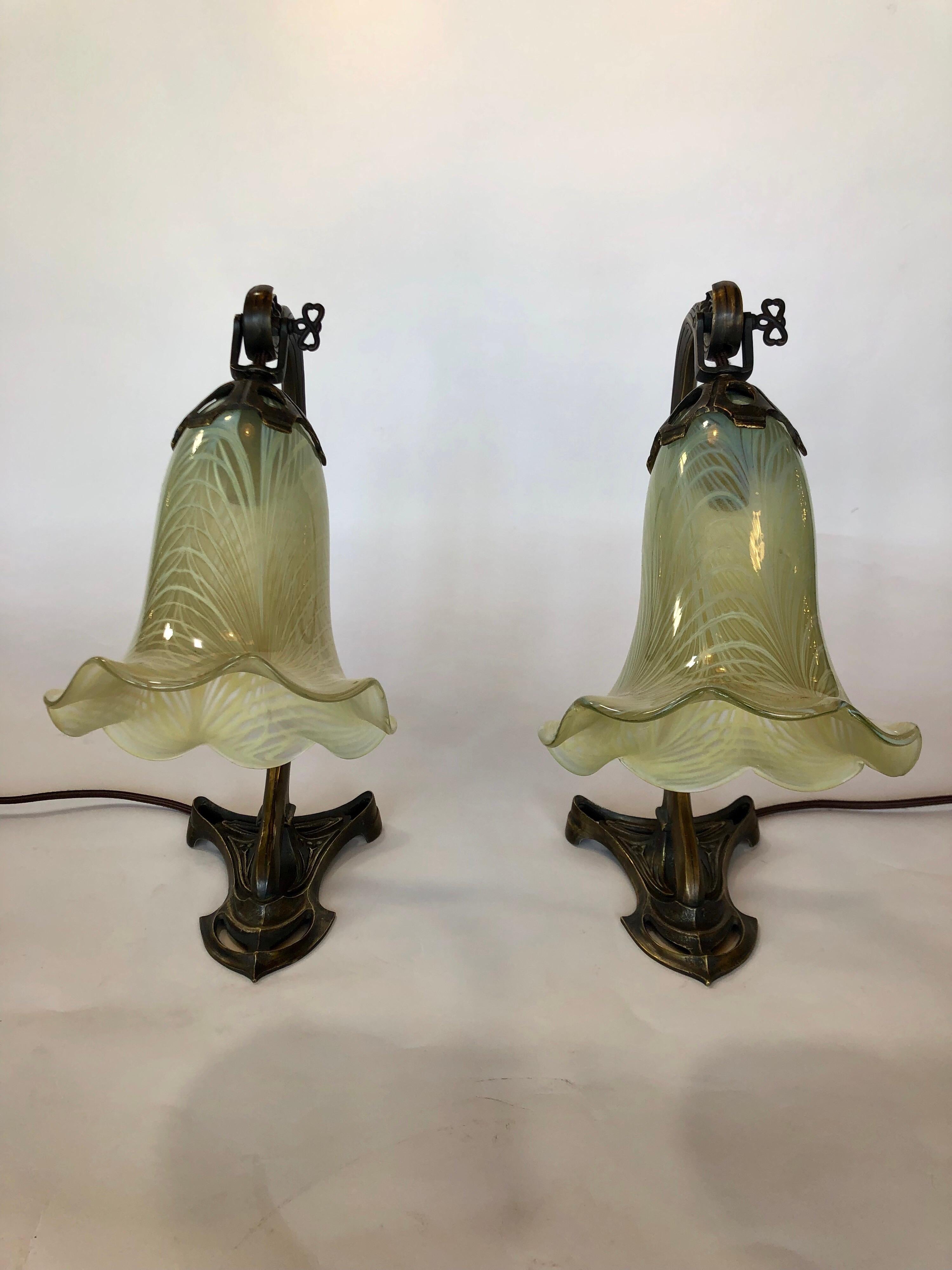 Pair of bronze Art Nouveau table lamps with glass shade.