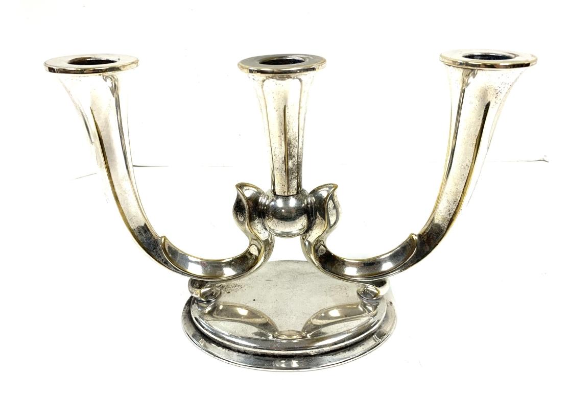 Pair of Art Nouveau style German silver-plate three light candleholders by WMF Württembergische Metallwarenfabrik.  The candleholder with three trumpet form holders conjoined with a sphere and surmounted on an oval base. Impressed WMF on