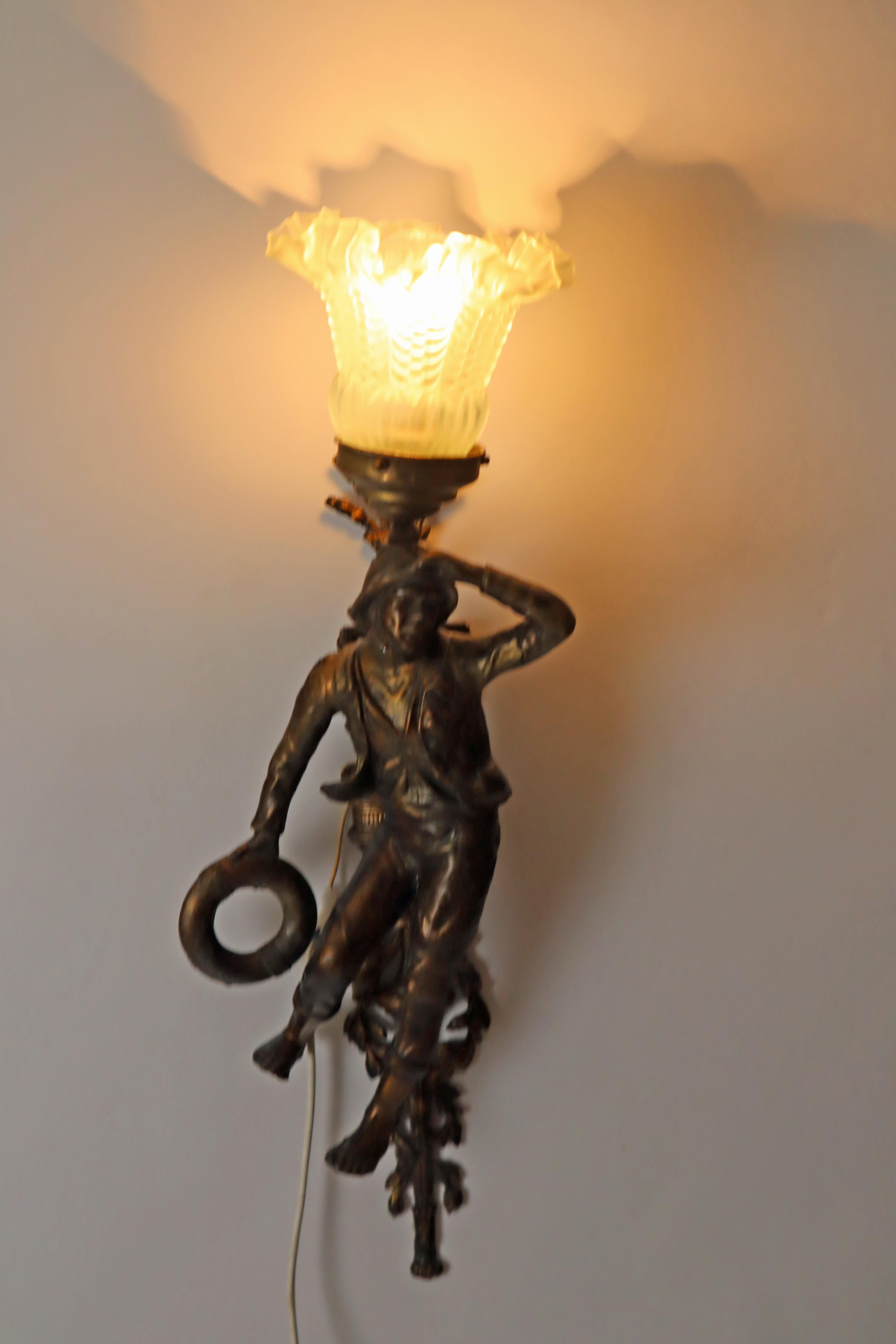 Questa coppia di lampade francesi è straordinaria. La prima lampada da parete ha la forma di una bella contadina. Il design artistico è impareggiabile. Il suo volto è delicatamente scolpito e ti sembrerà che ti stia sorridendo. Il vestito delicato