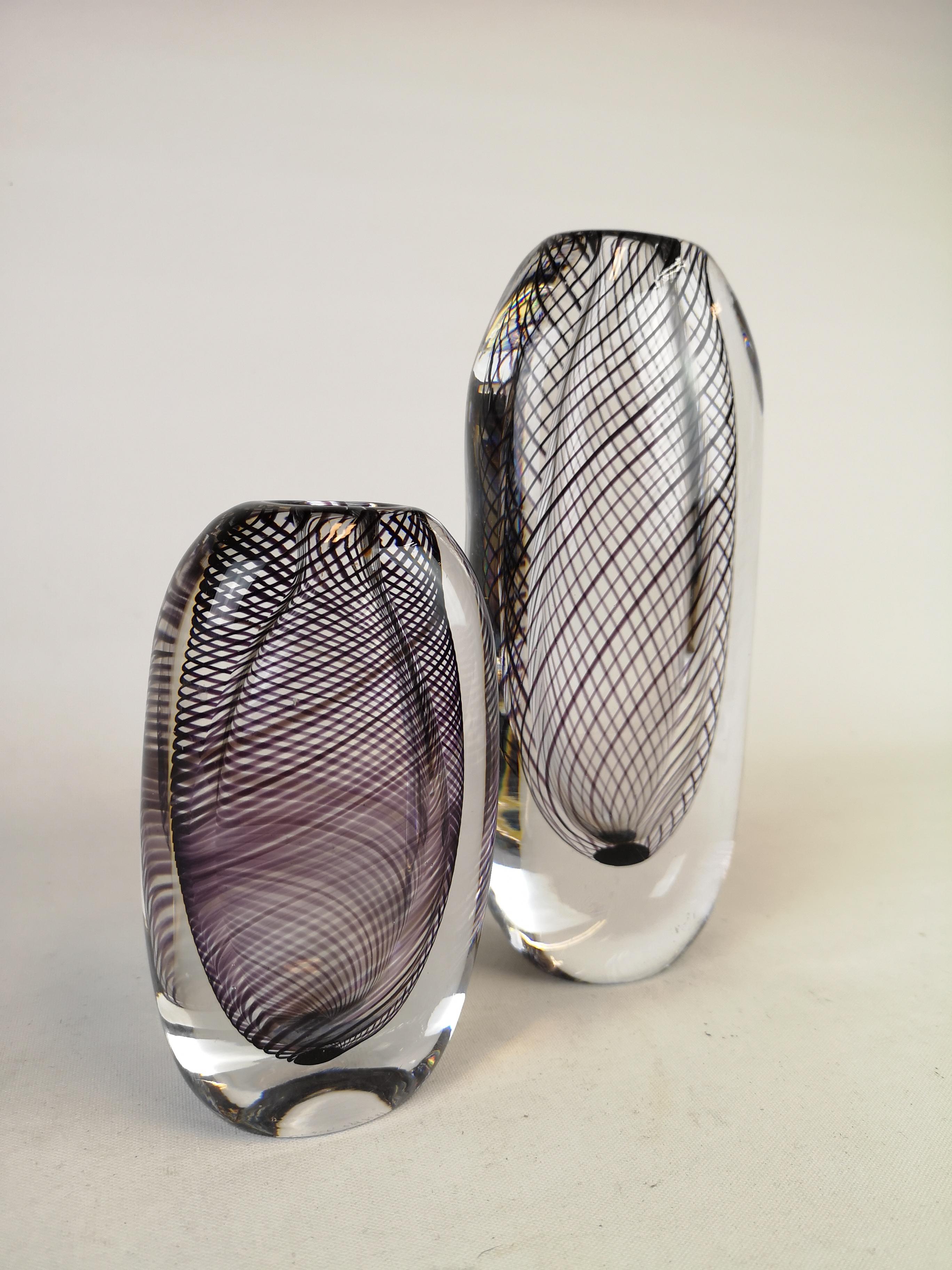 A pair of art vases produced in Sweden at the Kosta factory. Designed by Vicke Lindstrand. 
The vase is made of clear glass with black (aventurine) glass threads.

Signed on the floor with 