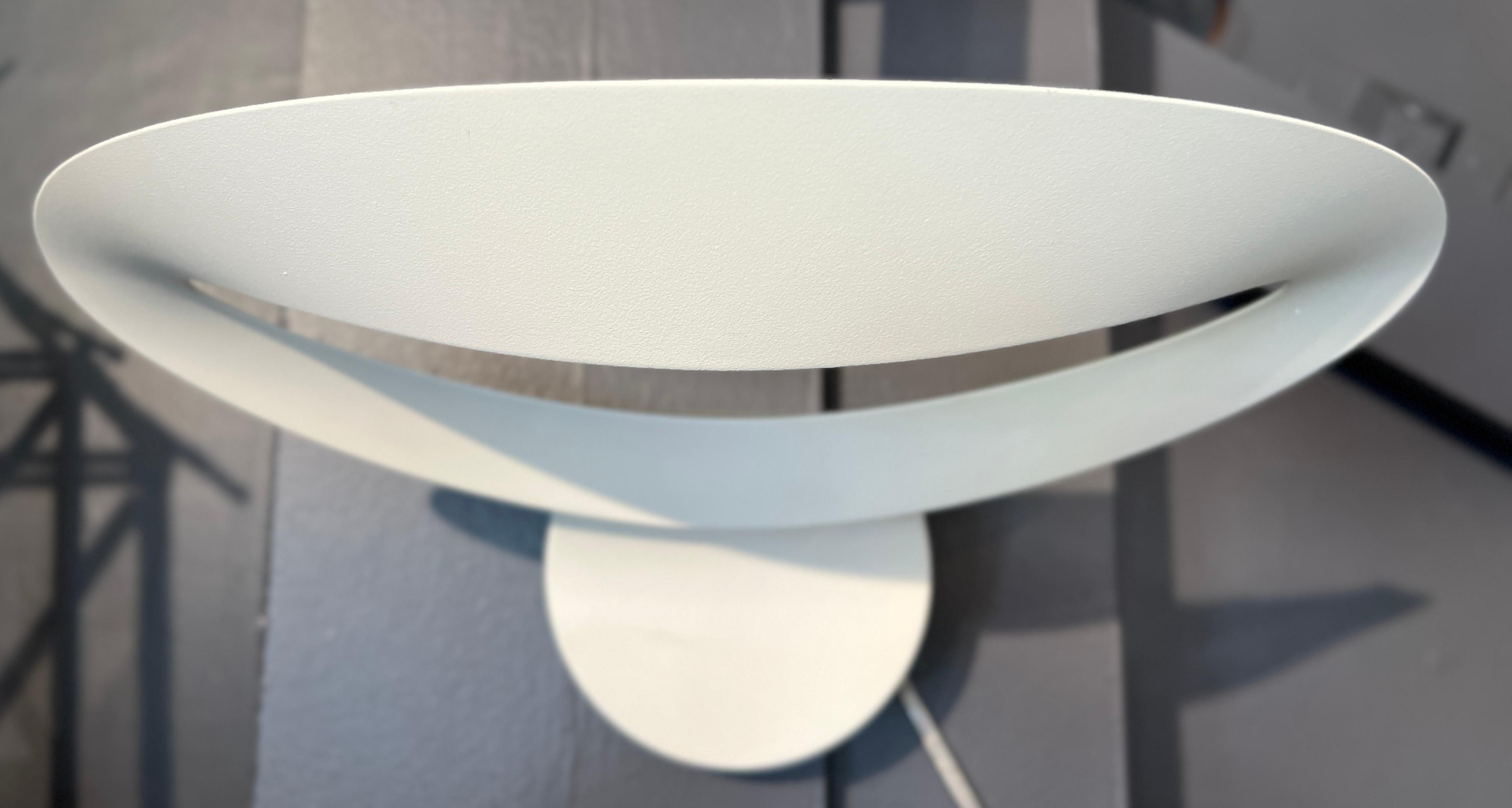 The Mesmeri Wall Sconce is a beautiful sculptural wall lamp designed by Eric Solé for Artemide in Italy. It has a curved aluminum design that hides its bright halogen light. You can adjust its brightness with a separate wall dimmer

Dimensions: 9