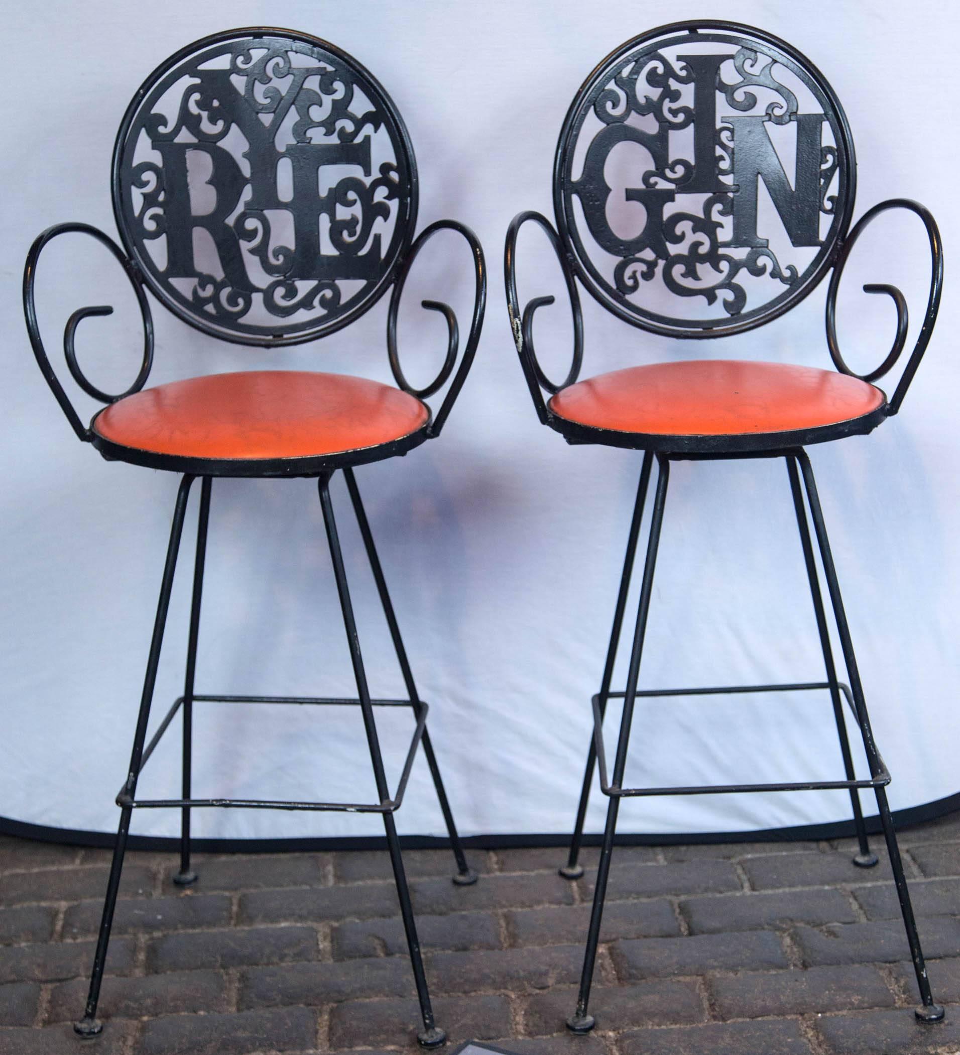 The swinging 1960s! Two 1960s wrought iron stools by Arthur Umanoff, Rye and Gin with orange vinyl seats. Seat height is 29.5 inches.