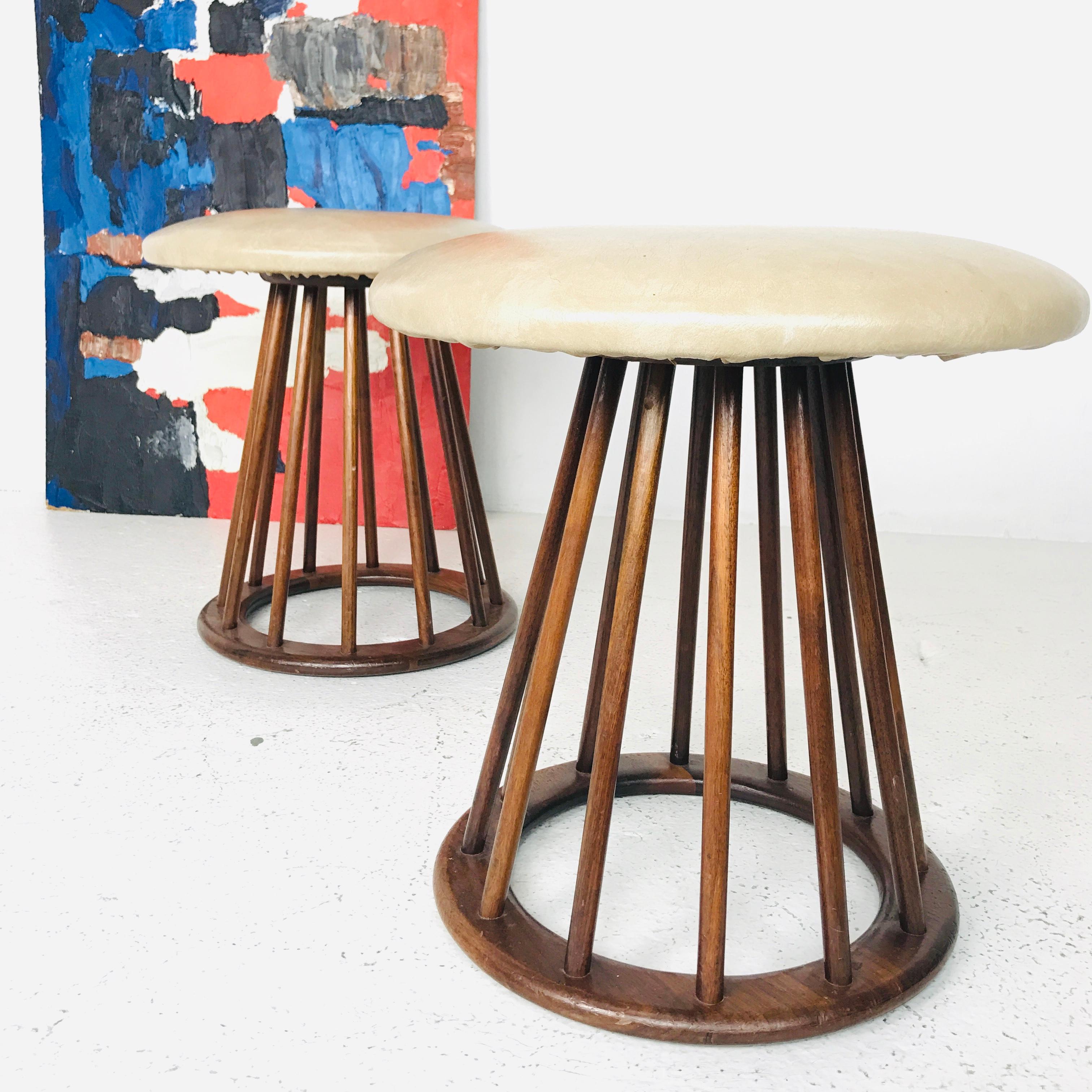 Pair of Arthur Umanoff MCM spindle stools. Stools have original vinyl upholstery and recommend new upholstery and refinishing, circa 1960s

Dimensions:
17dia x 16t.