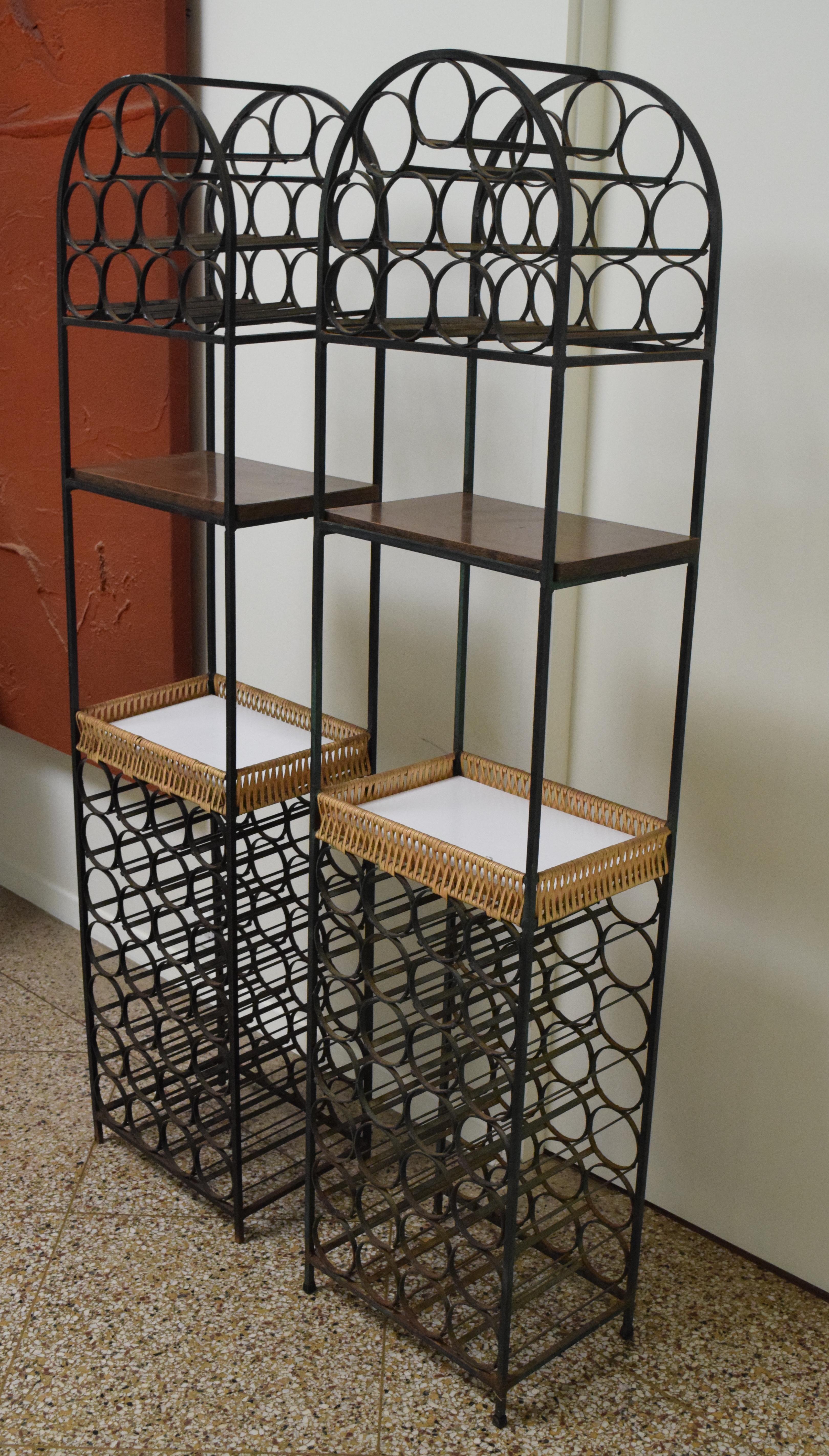 Store closing-- last day is 7/31. Offers welcome! Pair of wrought iron wine racks with wicker basket and laminate shelf designed by Arthur Umanoff for Shaver Howard and distributed by Raymor. 39-bottle capacity. Price is for the pair.

 