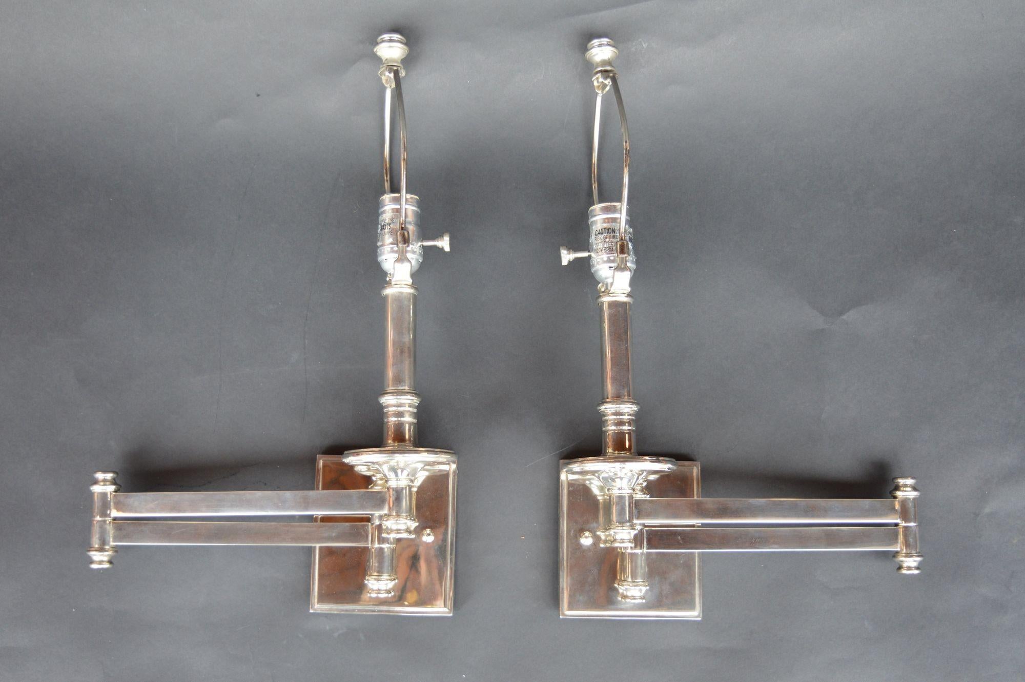 Pair of Nickel sconces with articulating arms. Measurements are with the arm fully extended.