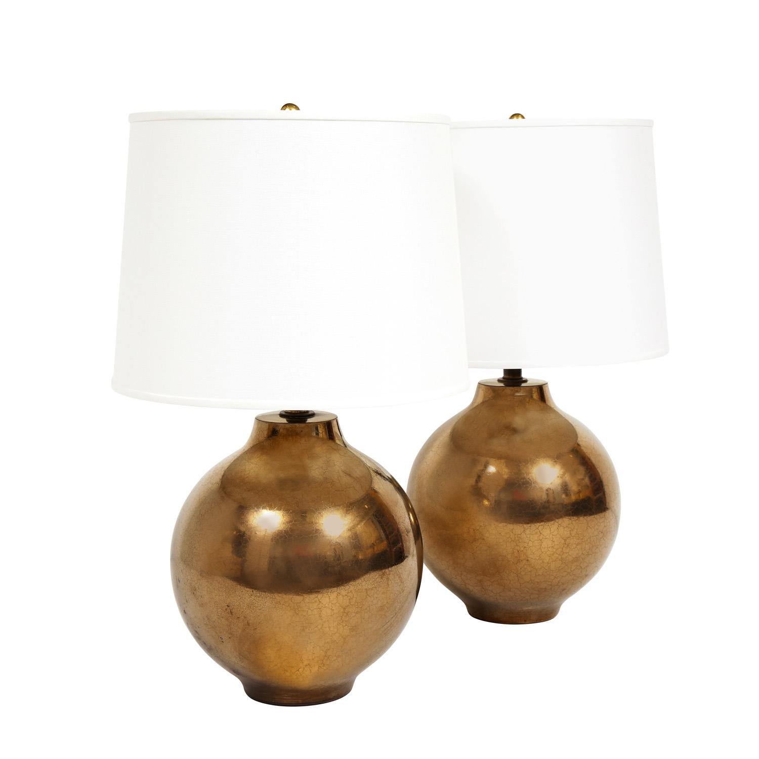 Elegant pair of artisan ceramic table lamps with craquele bronze gold glaze with bronze hardware, American 1970's. The color and glaze are beautiful.

Measures: Shade Diameter: 16 inches
Shade High: 12 inches.