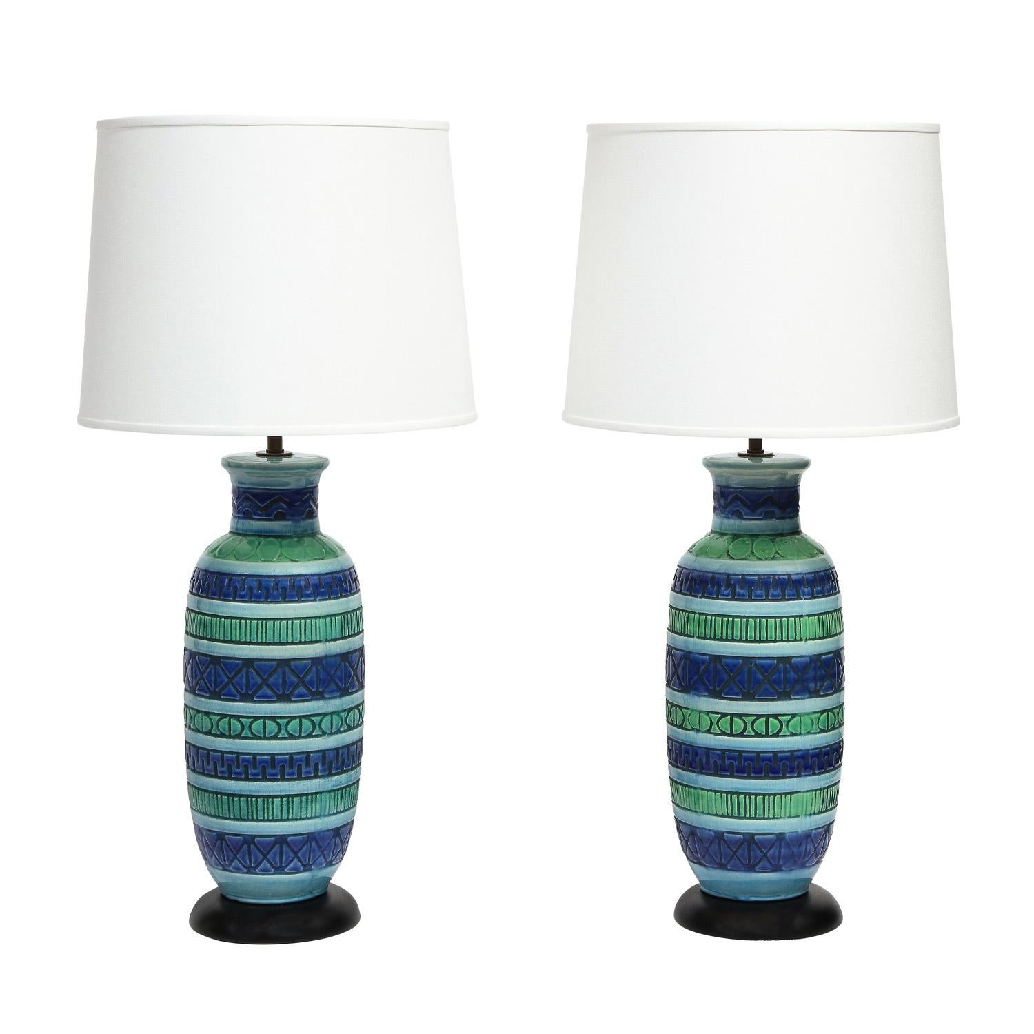 Pair of large hand-thrown ceramic table lamps, hand-painted and glazed in blue and green, on dark wood bases with bronze hardware, Italian 1950's. Newly rewired with bronze hardware and silk cords. Bases refinished. In like-new