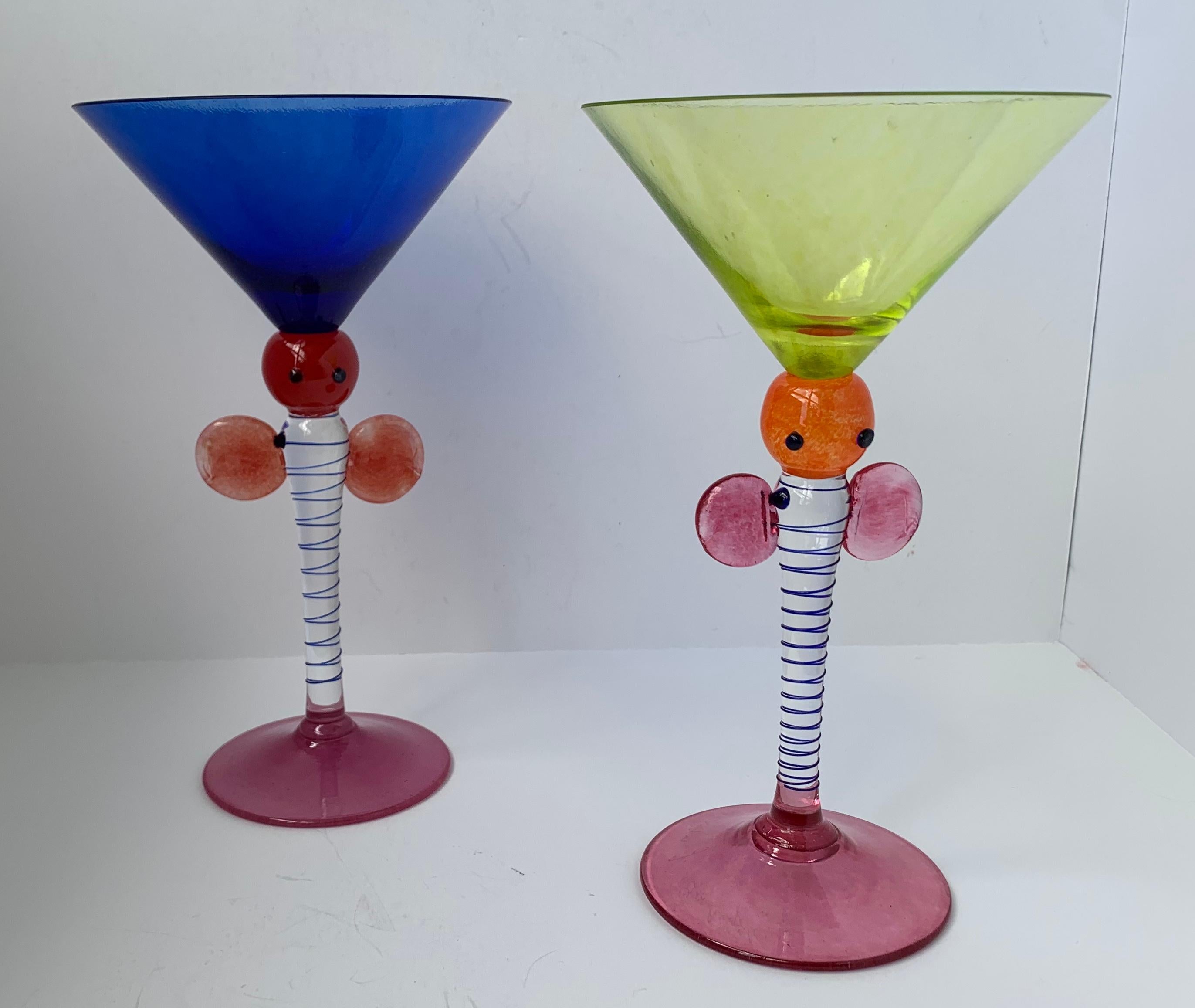 Pair of whimsical and very colorful cocktail glasses. They are mouth blown and have applied cobalt blue glass threading on the stems. The eyes and perhaps big ears add a touch of humor. Signed J. Guliajile.