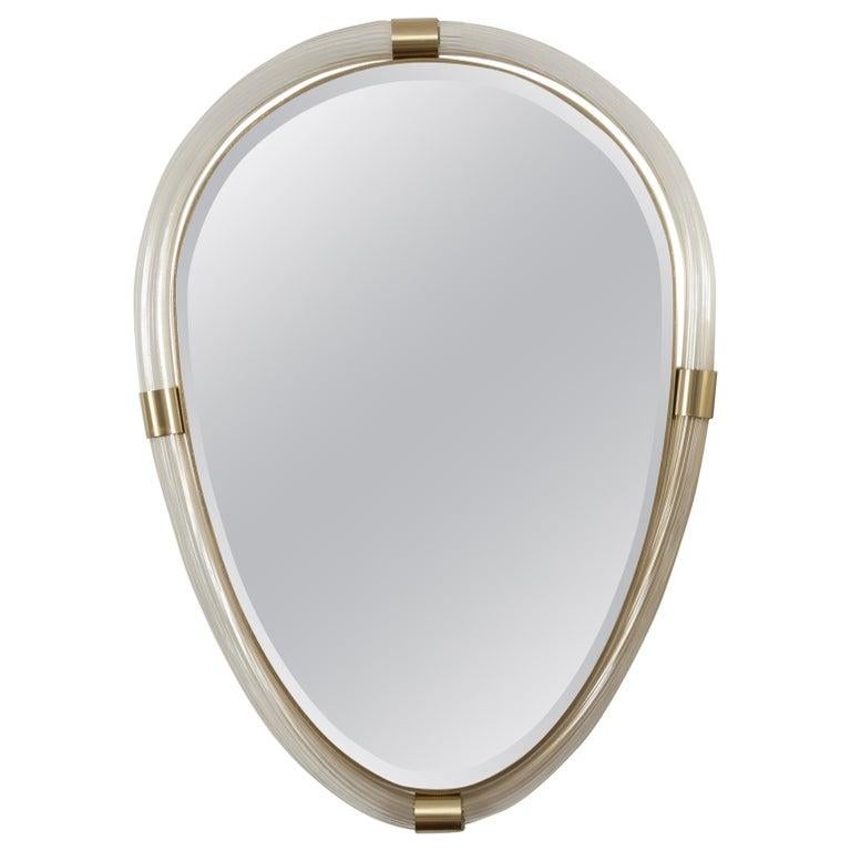 Pair of Murano glass blown transparent and 23K gold reeded torchere tubes joined by unlacquered brass fittings to form a lovely oval shaped mirror with bevelled looking glass. This new style is inspired by the Art Deco Barovier Mirrors from the
