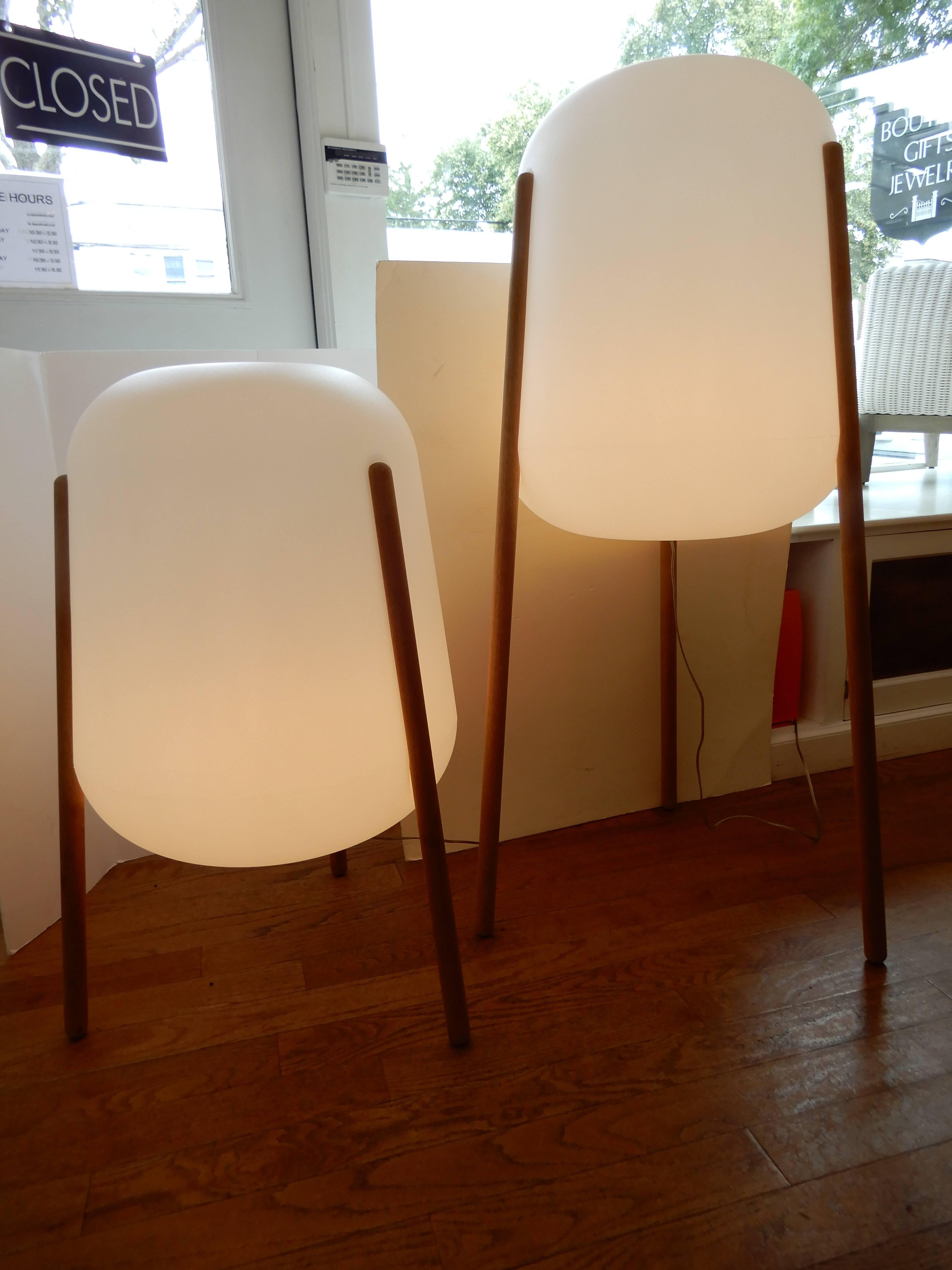 Pair of artisan indoor/outdoor tripod floor lamps. Resin encasement and tropical hardwood legs. The Lunar Lights provide a calm and warming aura especially at night with the ambiance of a lantern, substantial lighting for night time gatherings.