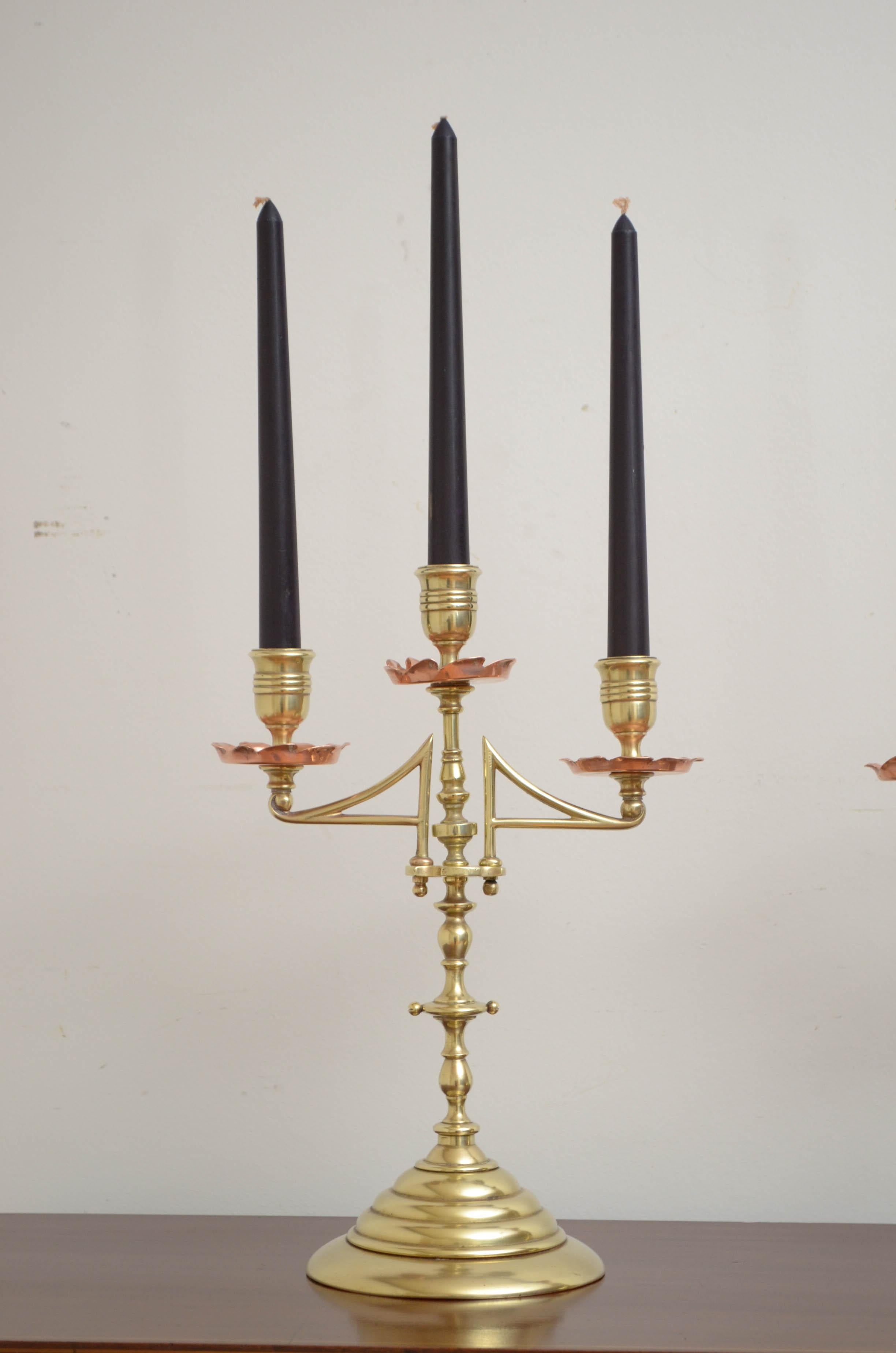 Stylish Arts & Crafts brass and copper candlestick holders. This pair of antique candlestick holders comes apart to enable easy cleaning. The pair has been cleaned and polished and is ready to use at home, circa 1900
Measures: H 13.5