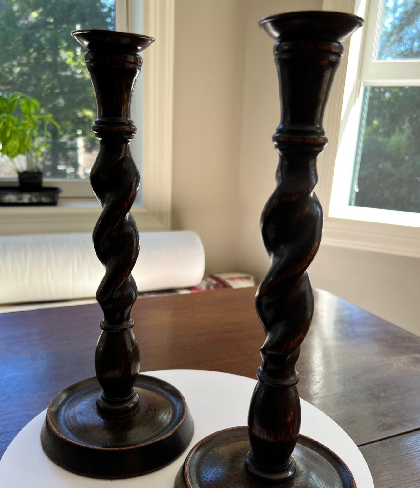 A pair of English Oak barley twist candlesticks from the Jacobean Revival period.  They would make a wonderful gift for the collector of English antiques. What a handsome addition to a country house decor, a library or guest bedroom. We all know