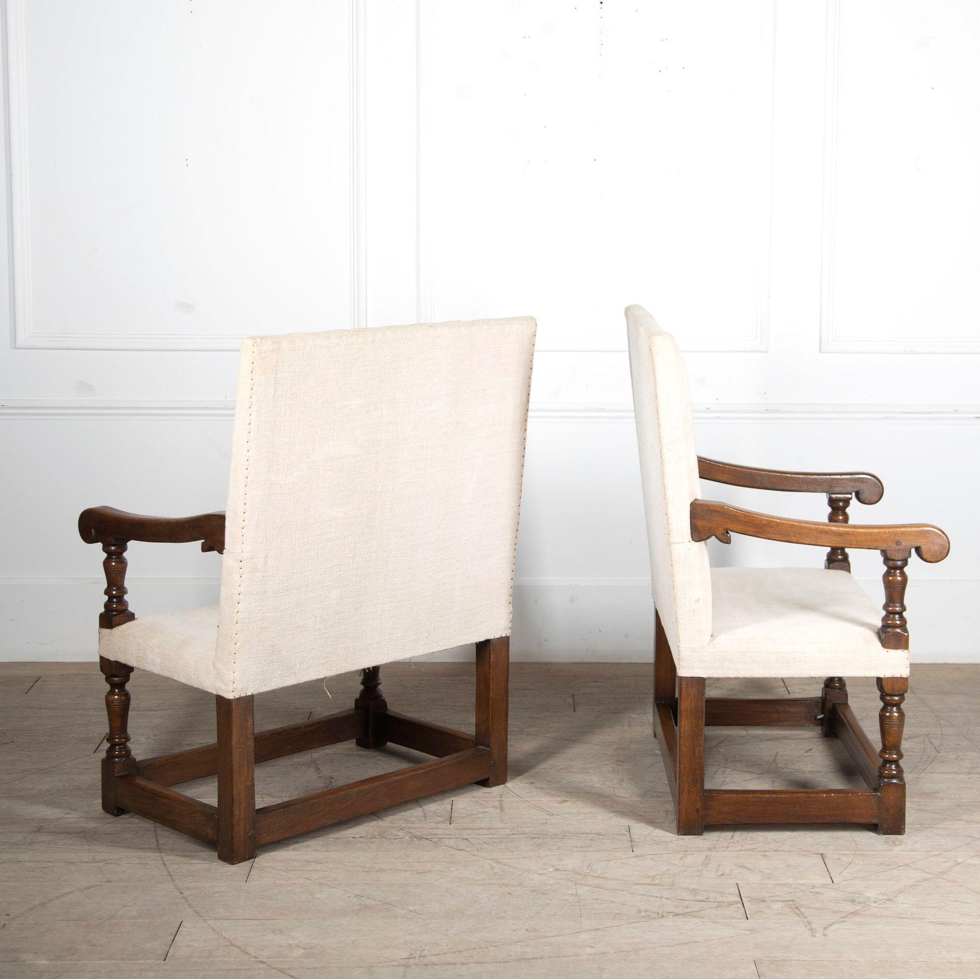 Pair of Arts and Crafts English oak farthingale armchairs.
These attractive chairs are in the 17th Century style with generous proportions.
Covered in French linen.