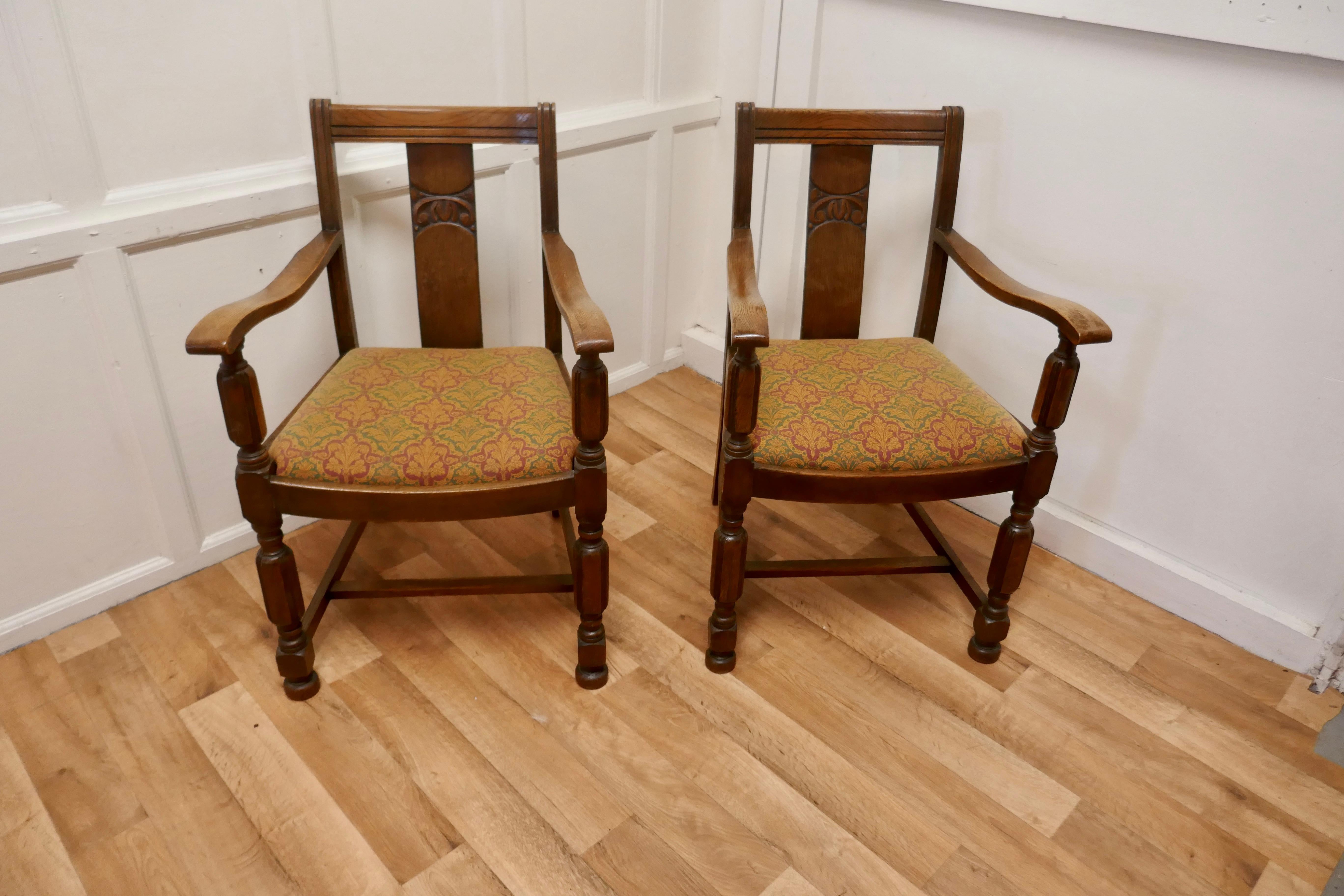 Pair of Arts & Crafts golden oak carver chairs.

A good pair of chairs very stout and sturdy, the oak has a lovely patina and the upholstery is good 
The chairs are 33” high, 47” wide and 18” deep.
TAC251.
 