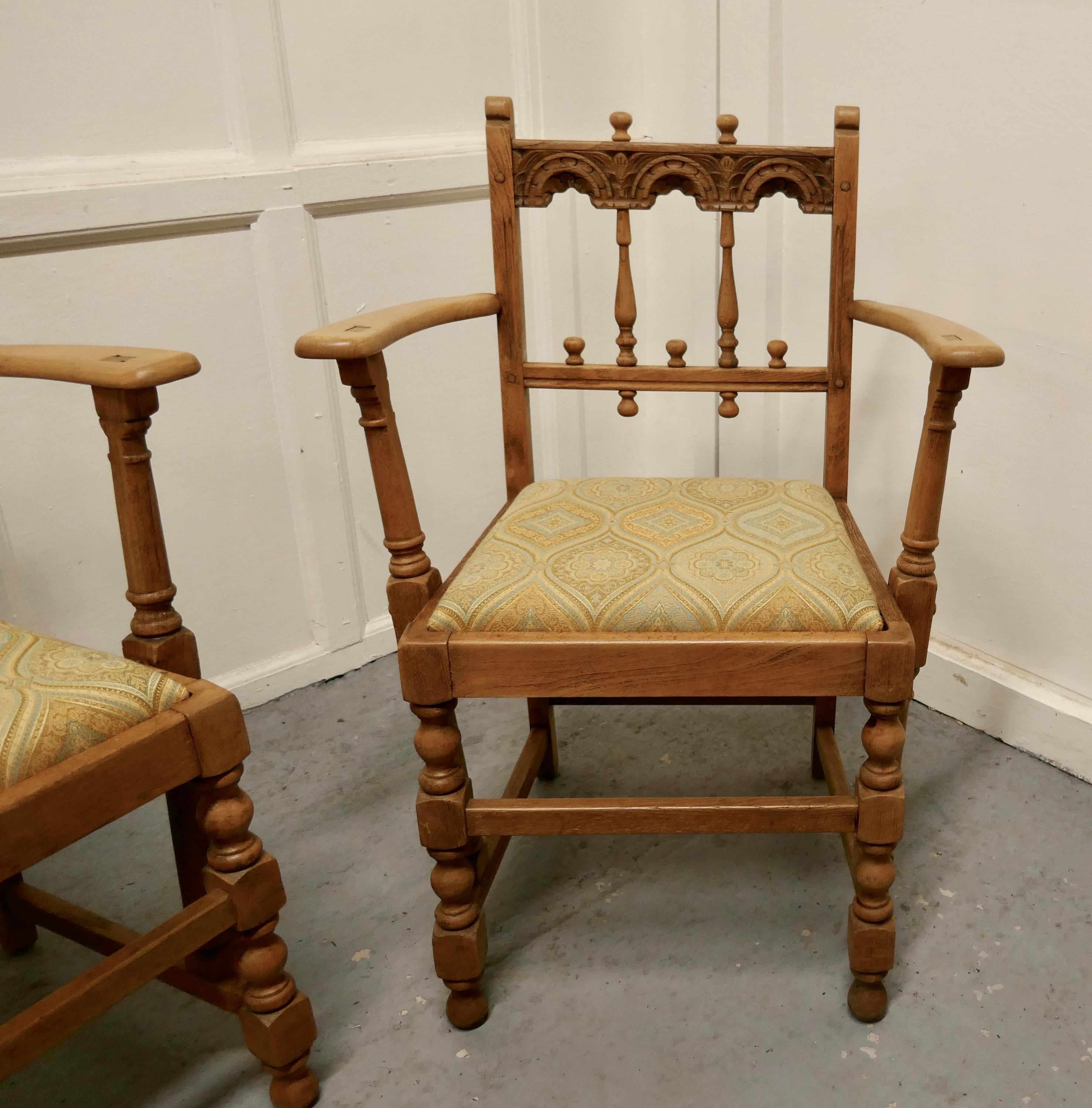 Pair of Arts & Crafts Gothic Bleached oak hall chairs

A good pair of chairs very stout and sturdy, the oak is bleached with age and the upholstery is good 
The chairs are 34” high, 25” wide and 18” deep
TGB406.