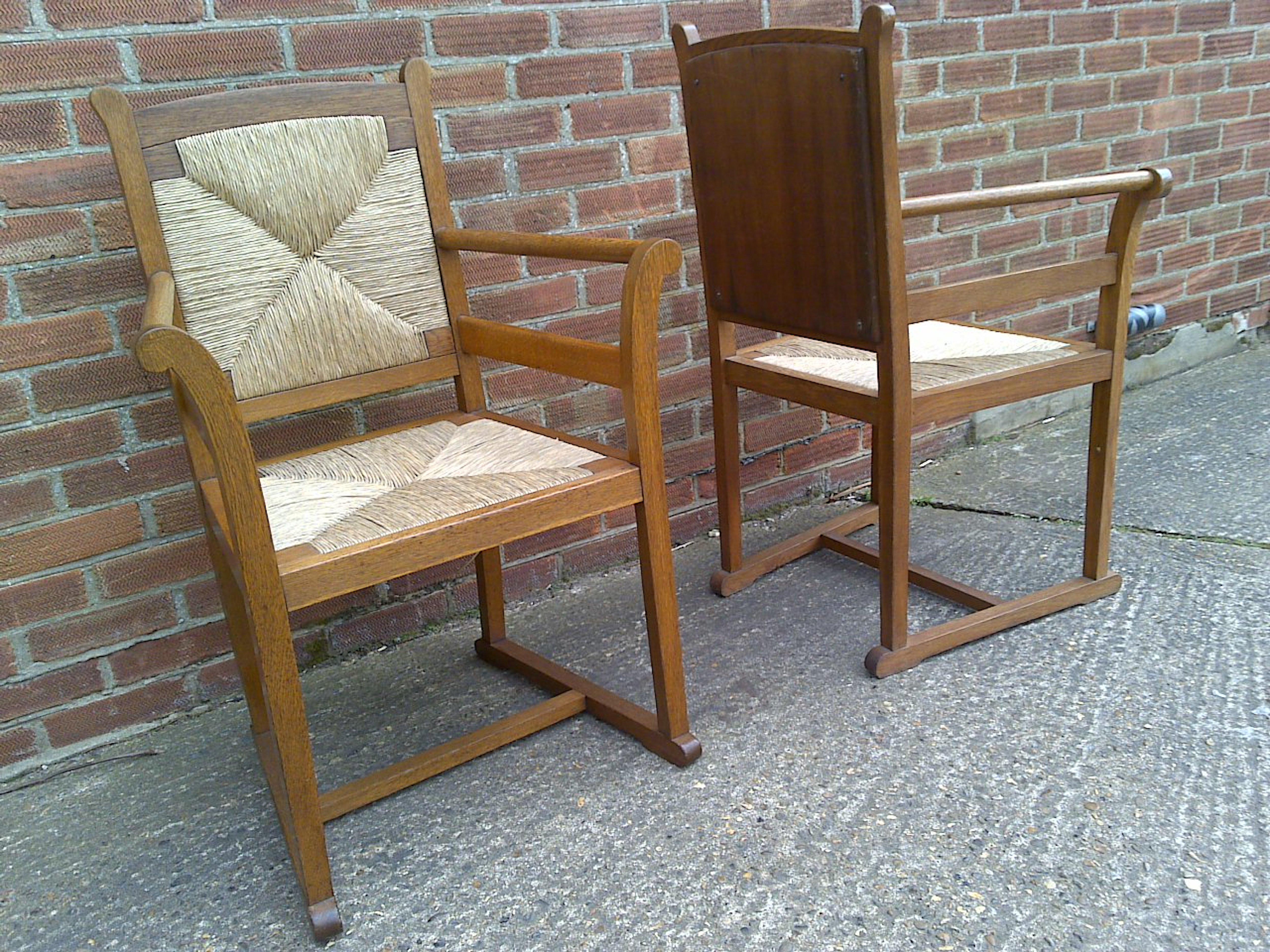 Rush Pair of Arts and Crafts Oak Elbow Chairs, in the Manner of George Walton For Sale