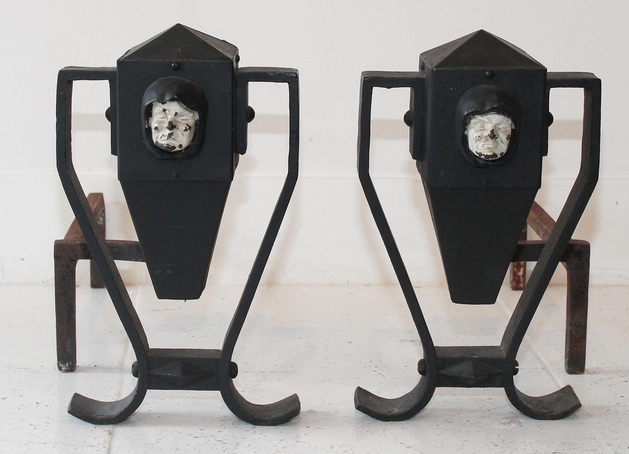 Perfectly patinated early 20th century Arts & Crafts handwrought andirons feature white-painted cast iron monks.