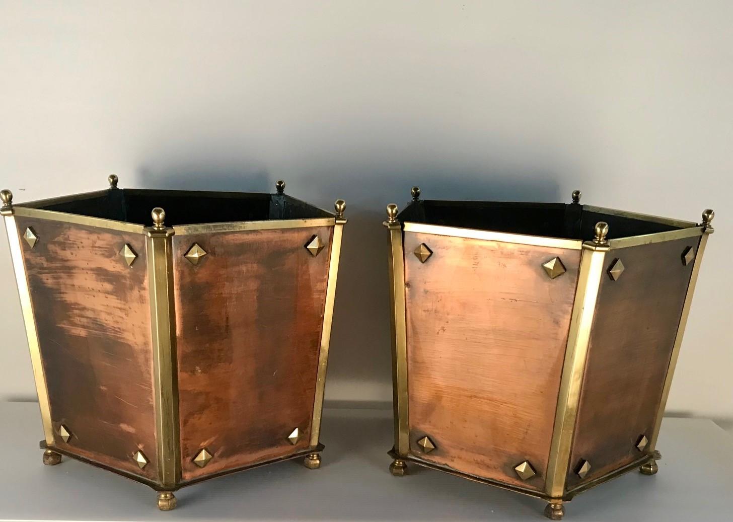 This unique pair of Arts and Crafts jardinières are a great example of the design and craftmanship of the Arts and Crafts movement. These pentagon shaped jardinières have the five copper sides attached at the five angles and are then sheaved in a