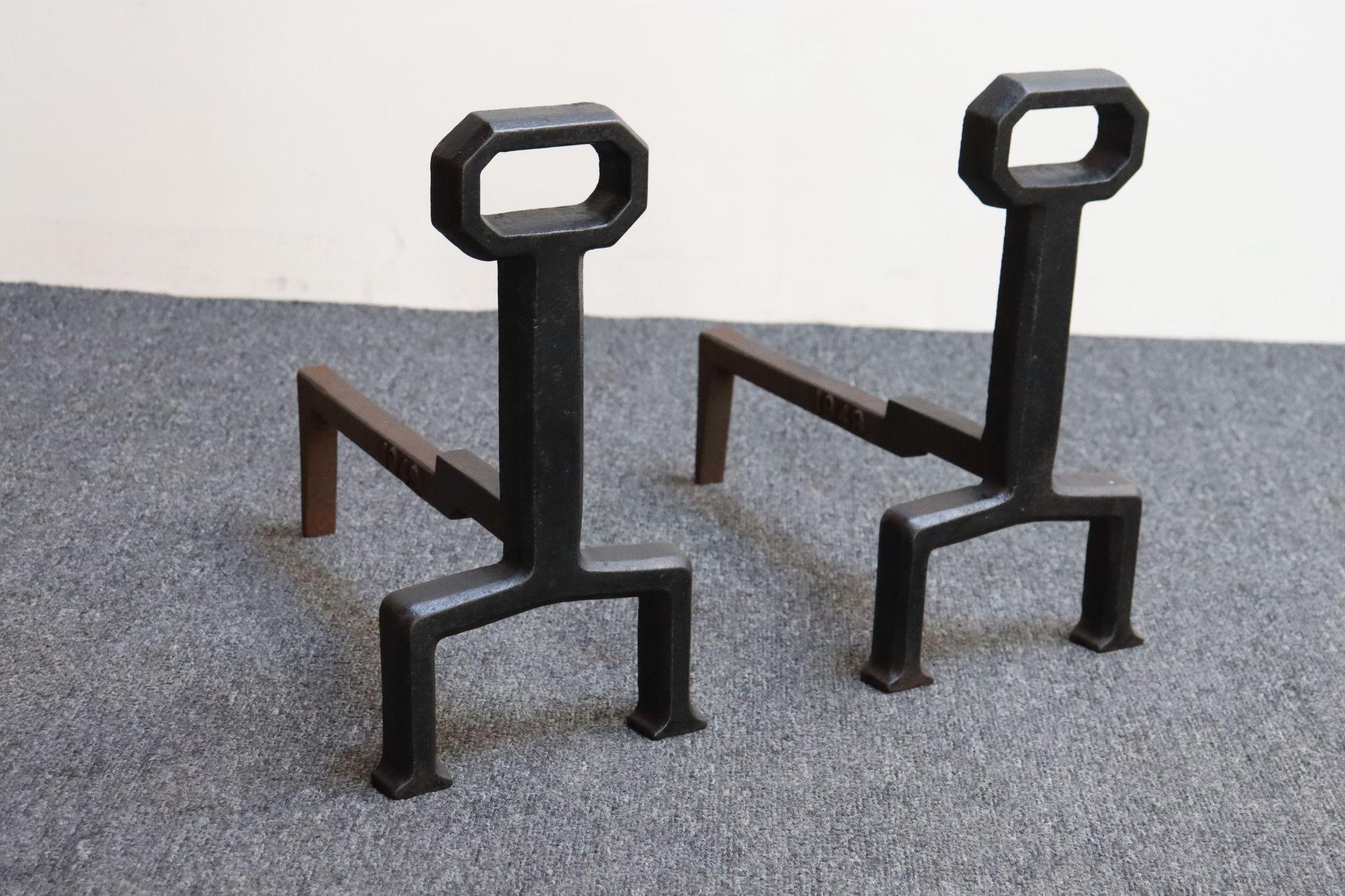 Arts & Crafts-style cast iron uprights attached to iron billet bars (1949, USA).
Petite form with minimal, geometric 'key-hole' design suitable for smaller fireplaces.
Very fine, vintage condition with natural patina/rust to the iron, as