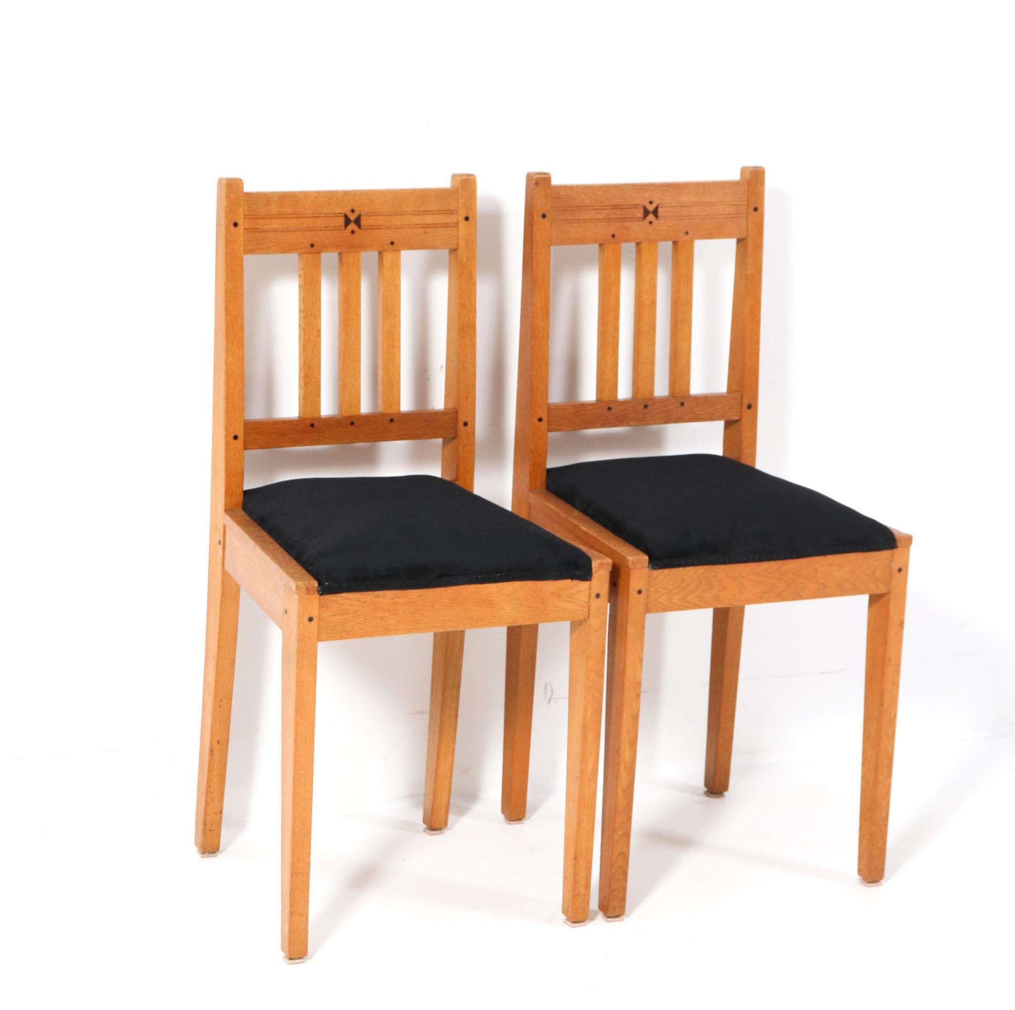 Magnificent and rare pair of Arts & Crafts Art Nouveau side chairs.
Design by Jac. van den Bosch.
Striking Dutch design from the 1900s.
Solid oak frames with decorative solid ebony pins.
Both seats are re-upholstered with a quality black velvet