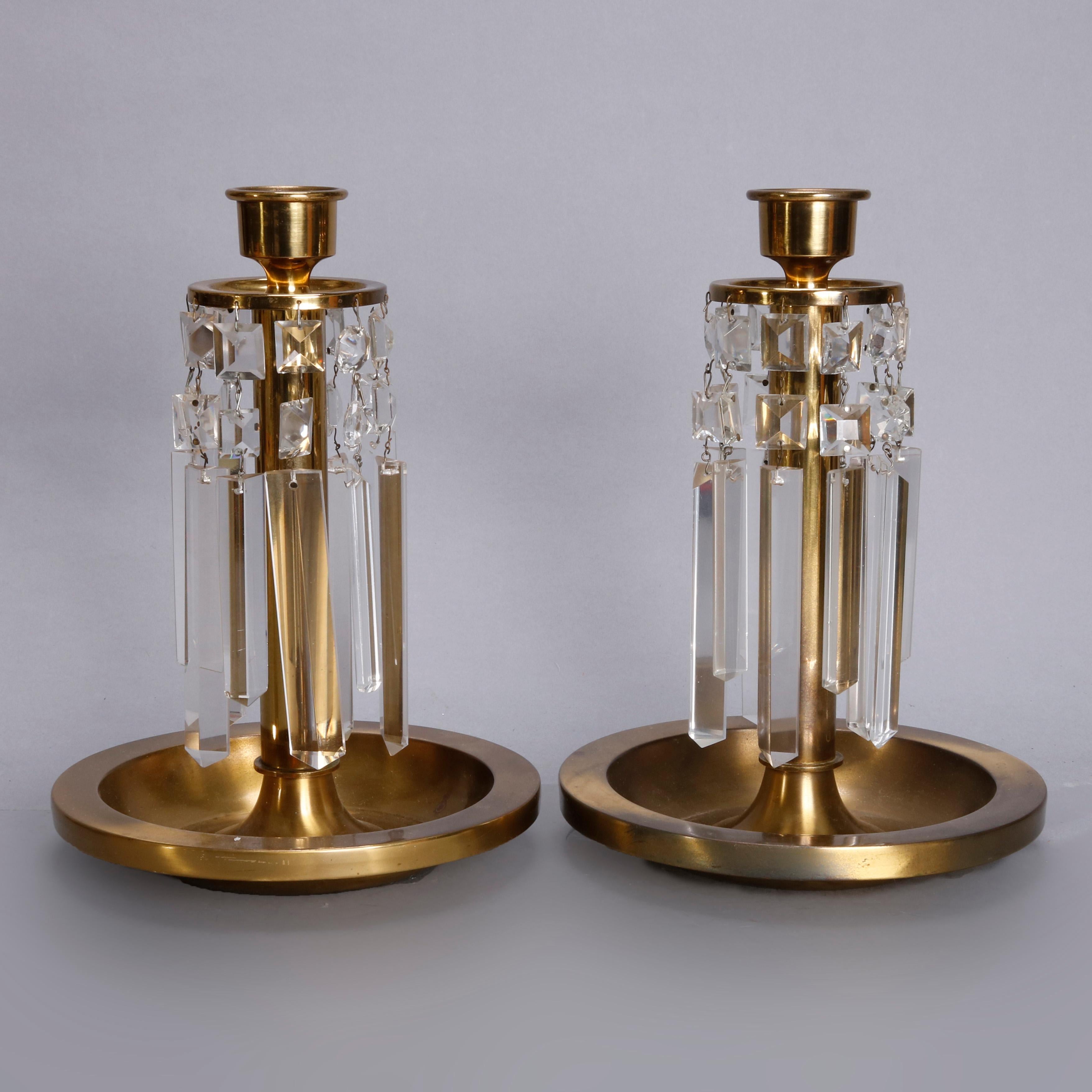 A pair of Arts & Crafts candlesticks each offer brass column form with a round base having a well and single candle socket with cut crystals, circa 1910

 Measures: 11.5