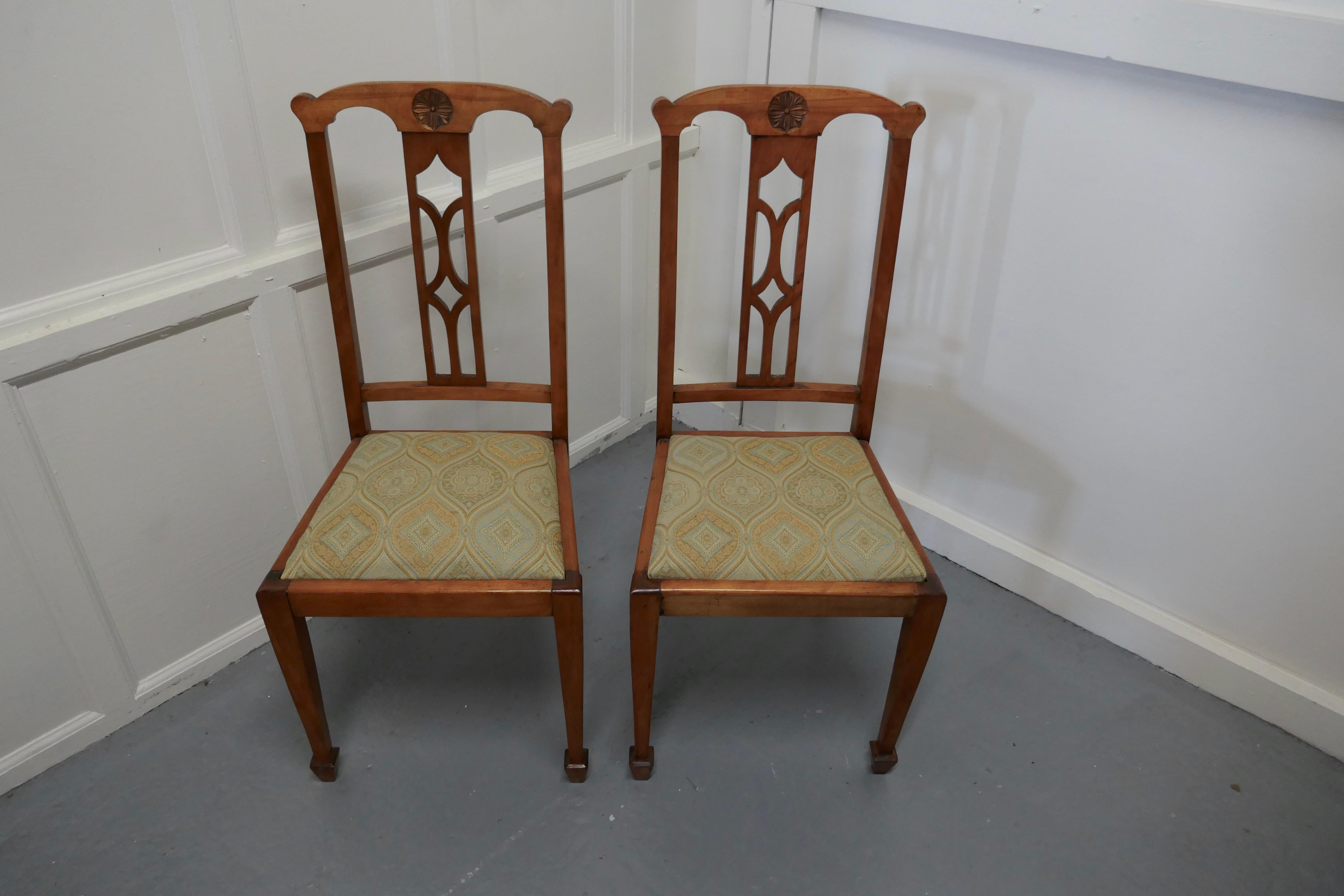 Pair of Arts & Crafts golden oak chairs 

 Very good high back Arts & Crafts oak chairs, this would make excellent hall chairs or spare dining chairs, the backs have a carved roundel set in the decorative back
The chairs have drop in seats which