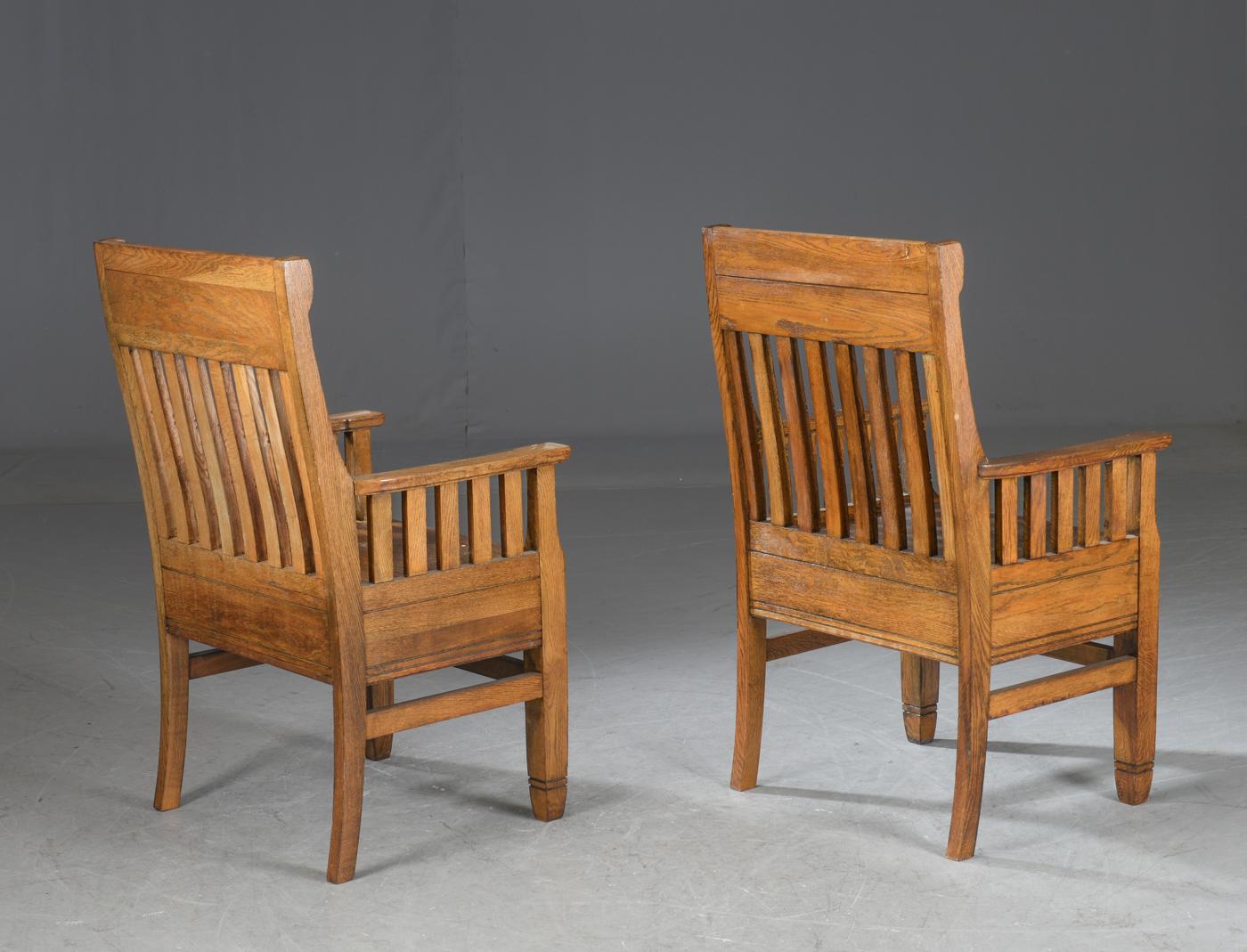 Pair of Arts & Crafts smoked oak armchairs. Hence the rich color. H. 105 cm. B. 63 cm. SH. 48 cm. Traces of wear. Danish, early 20th century.