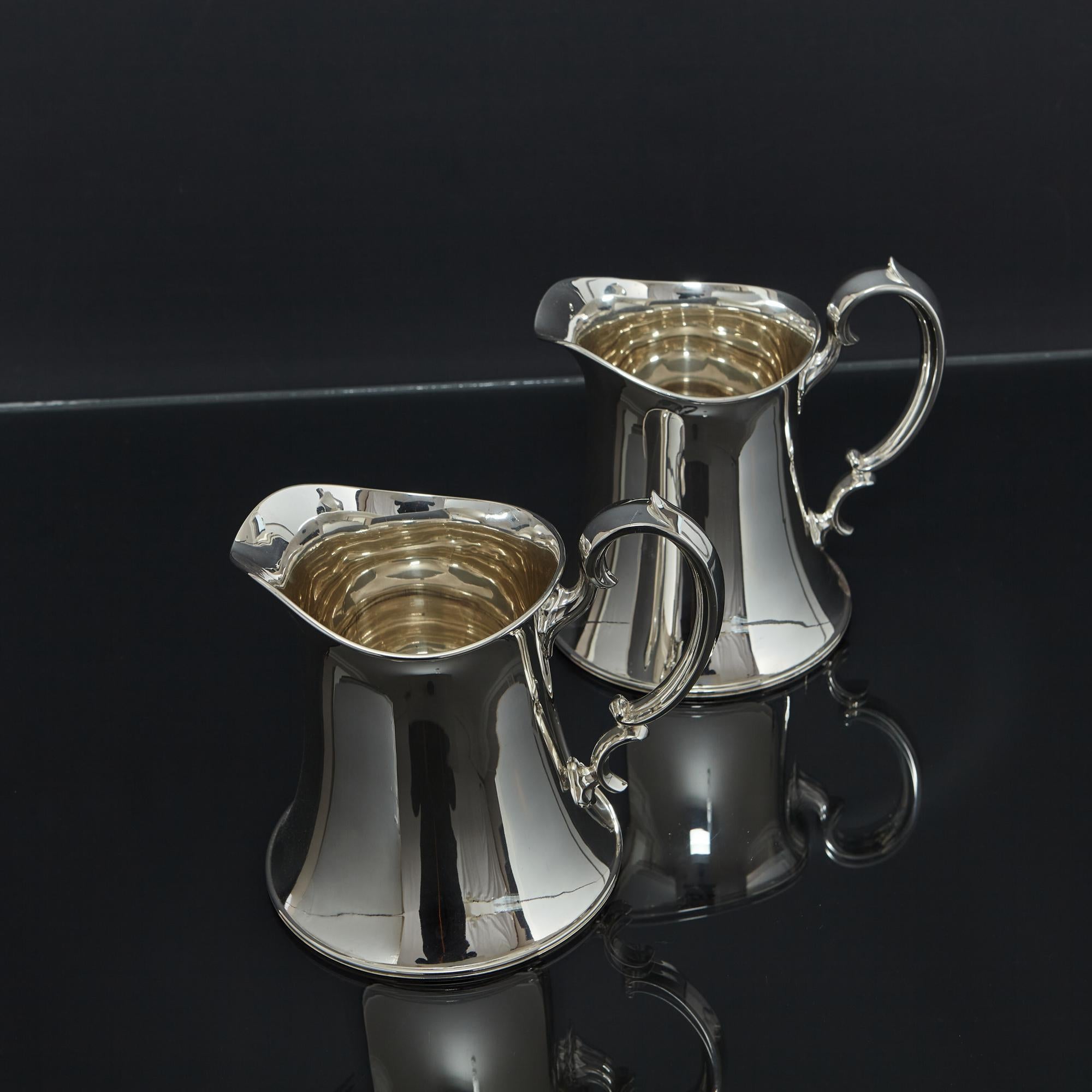 Arts and Crafts Pair of Arts & Crafts silver water jugs For Sale