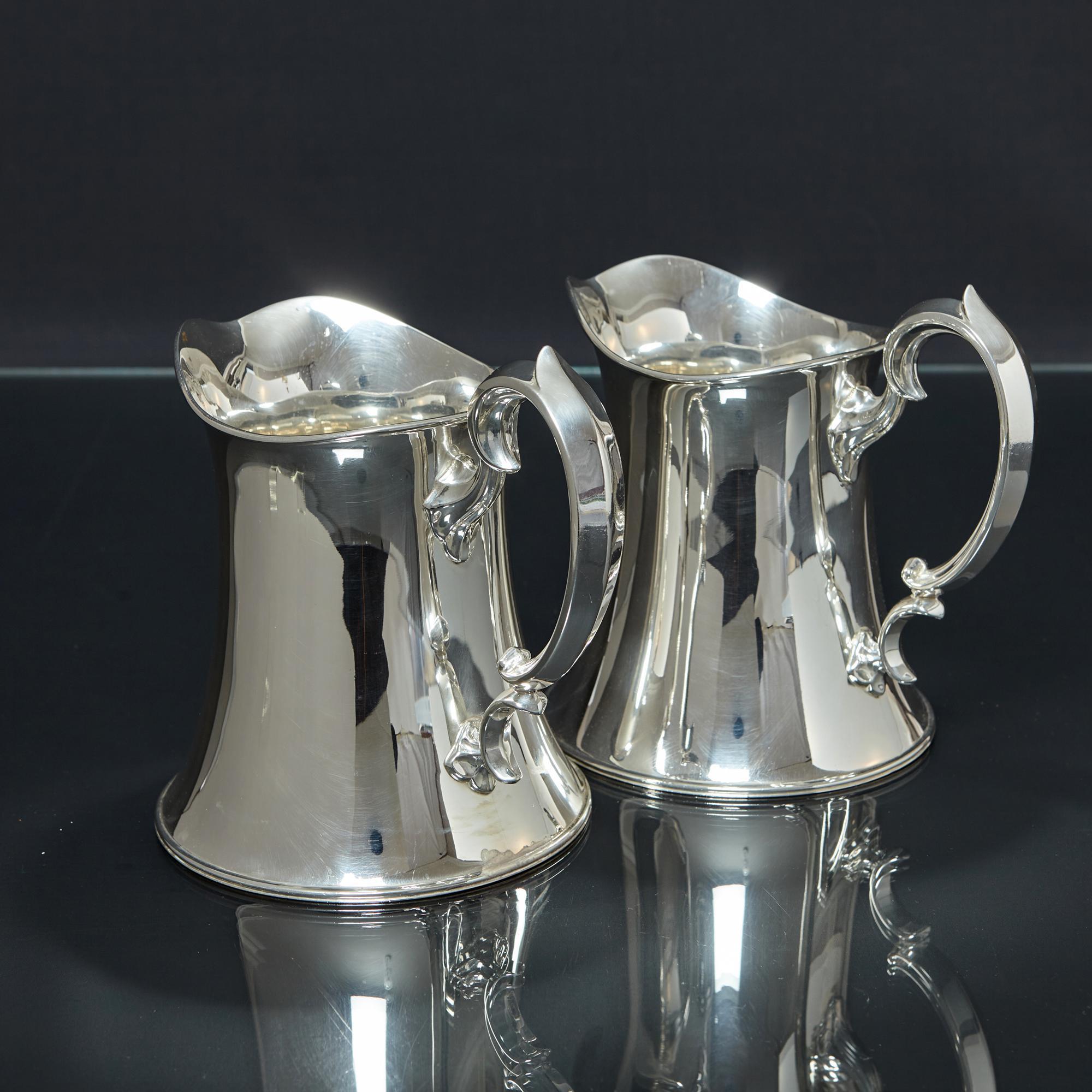 20th Century Pair of Arts & Crafts silver water jugs For Sale