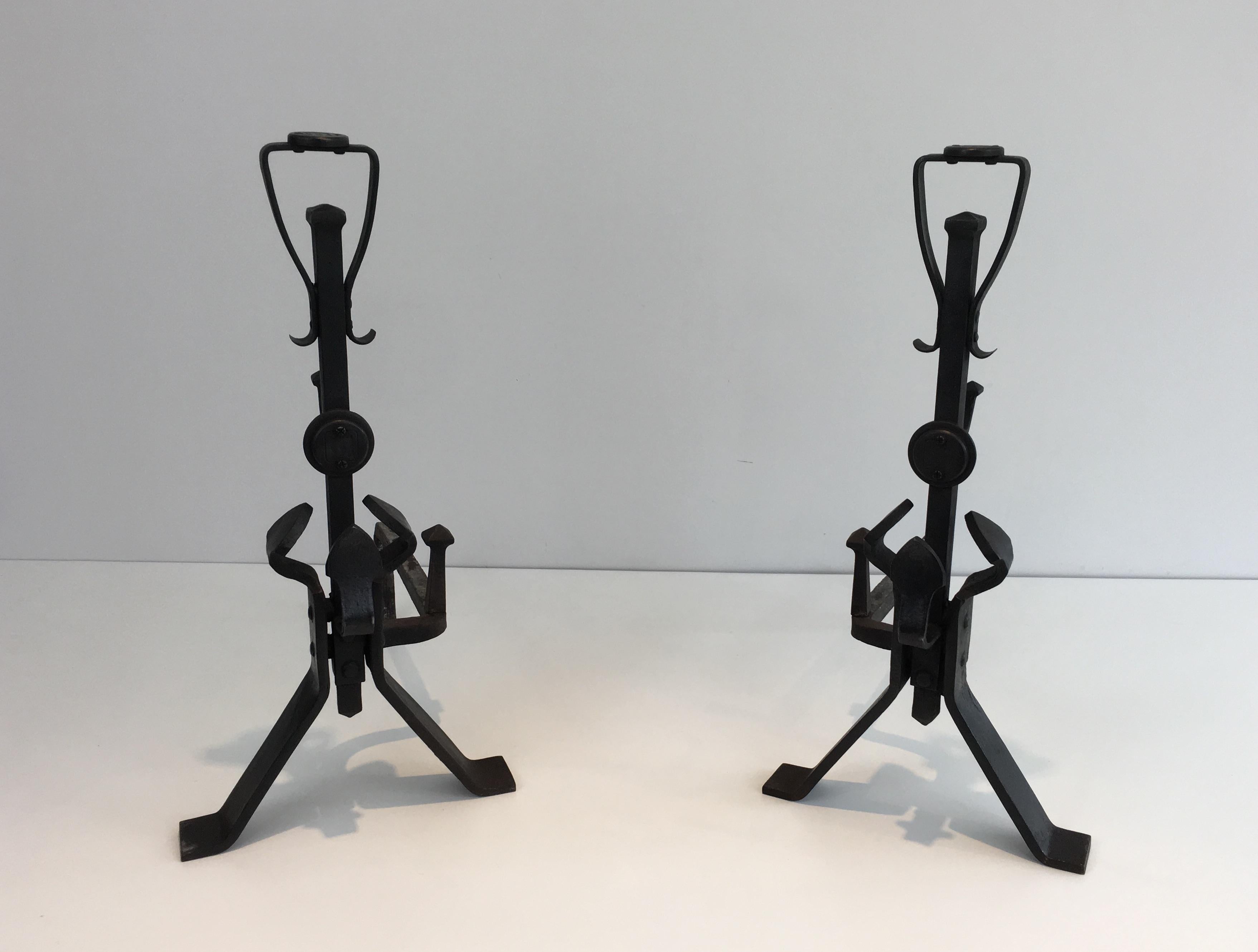 This pair of andirons is made of wrought iron. It is an interesting Arts & Crafts work, circa 1930.
