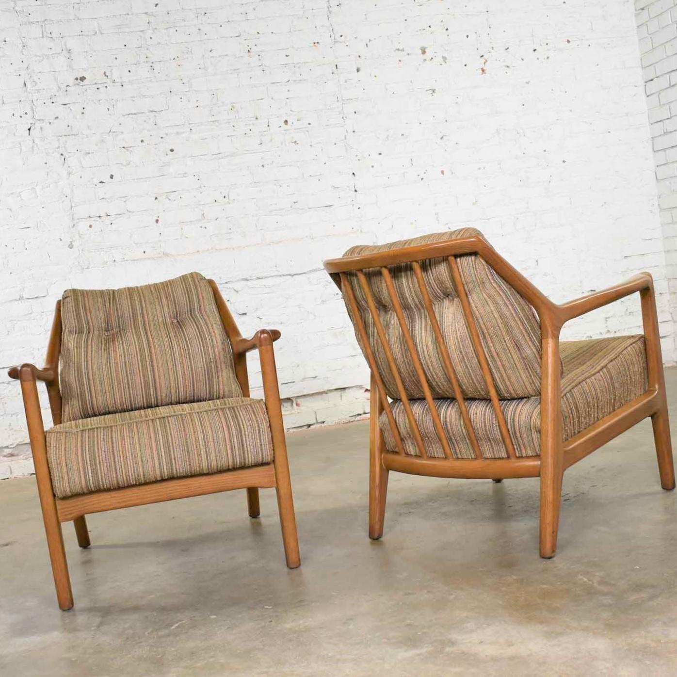 Handsome pair of Mid-Century Modern spindle back lounge club chairs by Jack Van der Molen for the Ash Group by Jamestown Lounge Company. In fact, these are No. 672 chairs. They wear their original fabric and tobacco finish which are in fabulous