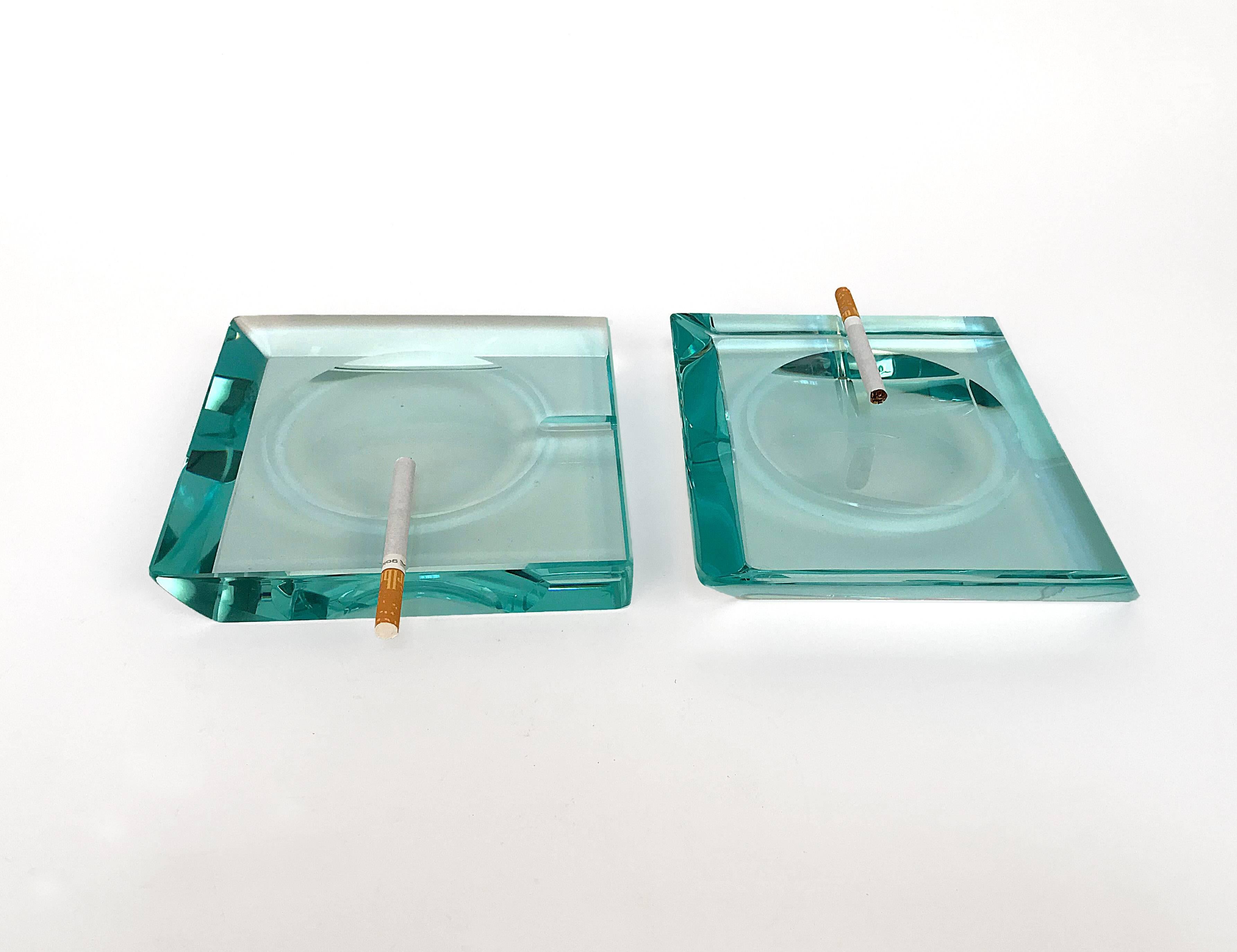 Pair of ashtrays by Fontana Arte.
Green glass, Classic of Fontana Arte, Italy. Two different ashtrays for shape and size.
Measurements: 6.70 x 6.70 - H 0.98
Measurements: 6.90 x 6.90 - H 1.10.