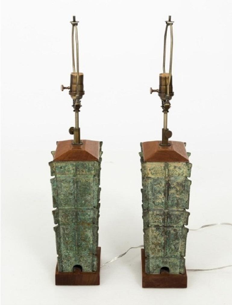 Pair of Asian style stacked bronze lamps with wood bases in a verdigris patina finish, circa 1910. Shades not included.
