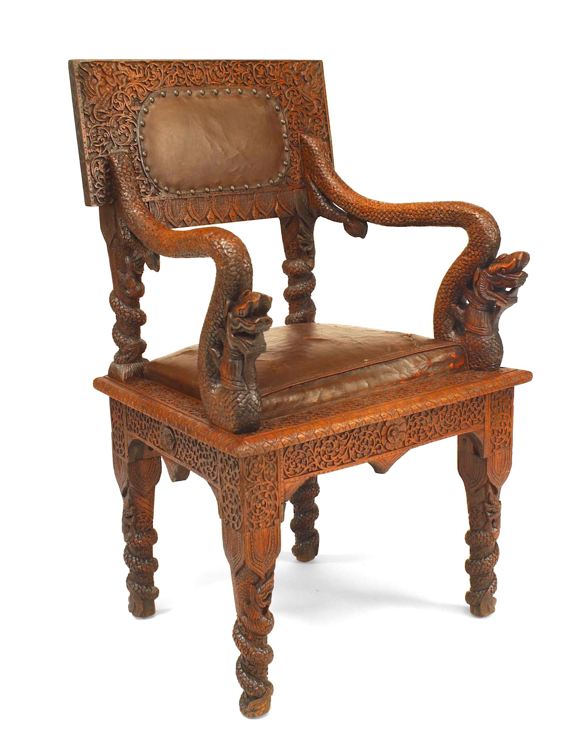 Pair of Asian Burmese style, 19th century oak carved armchair with square back and brown leather upholstered seat and back.

