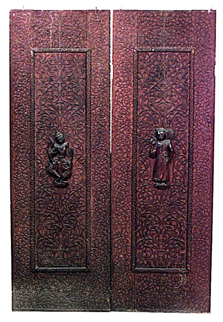 Pair of Asian Burmese style (19th Century) walnut carved door panels with figures and filigree border (PRICED AS Pair).
