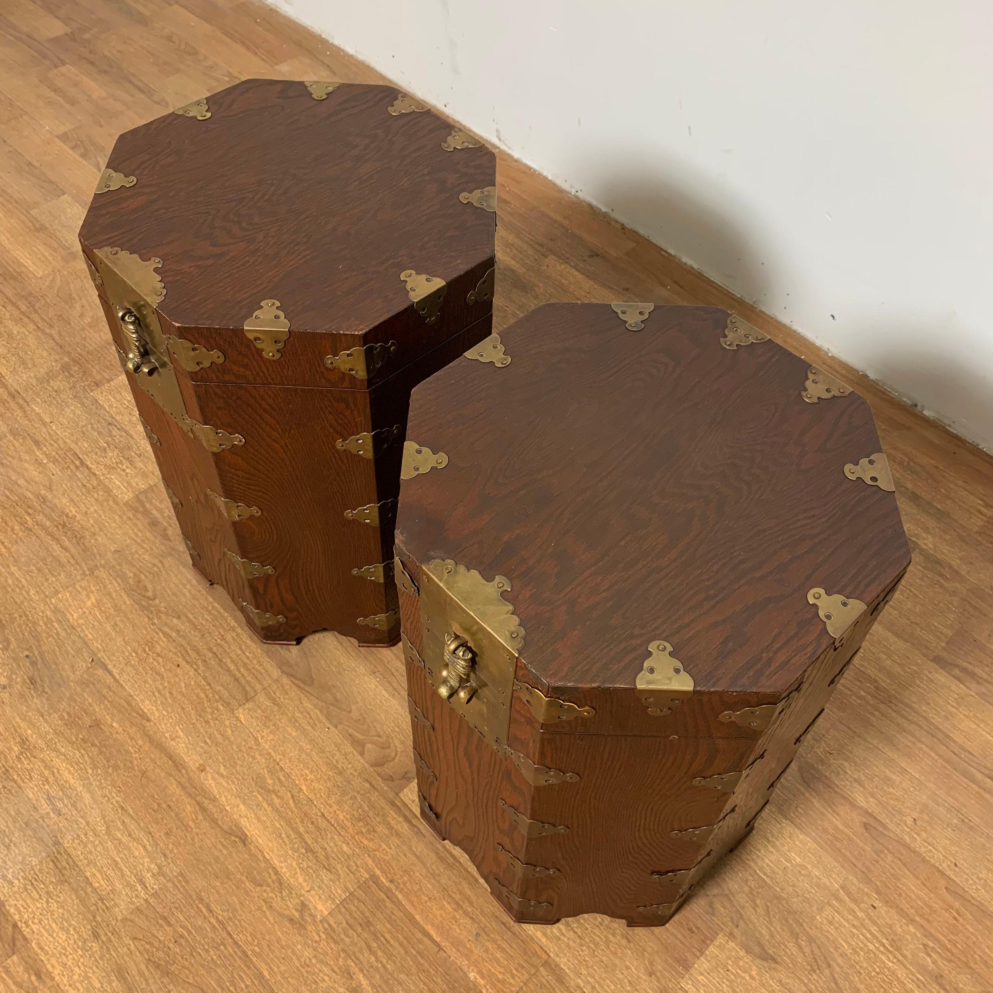 Pair of Asian campaign style octagonal lidded chests, perfect height for use as side tables. Mahogany and brass, circa 1950s.