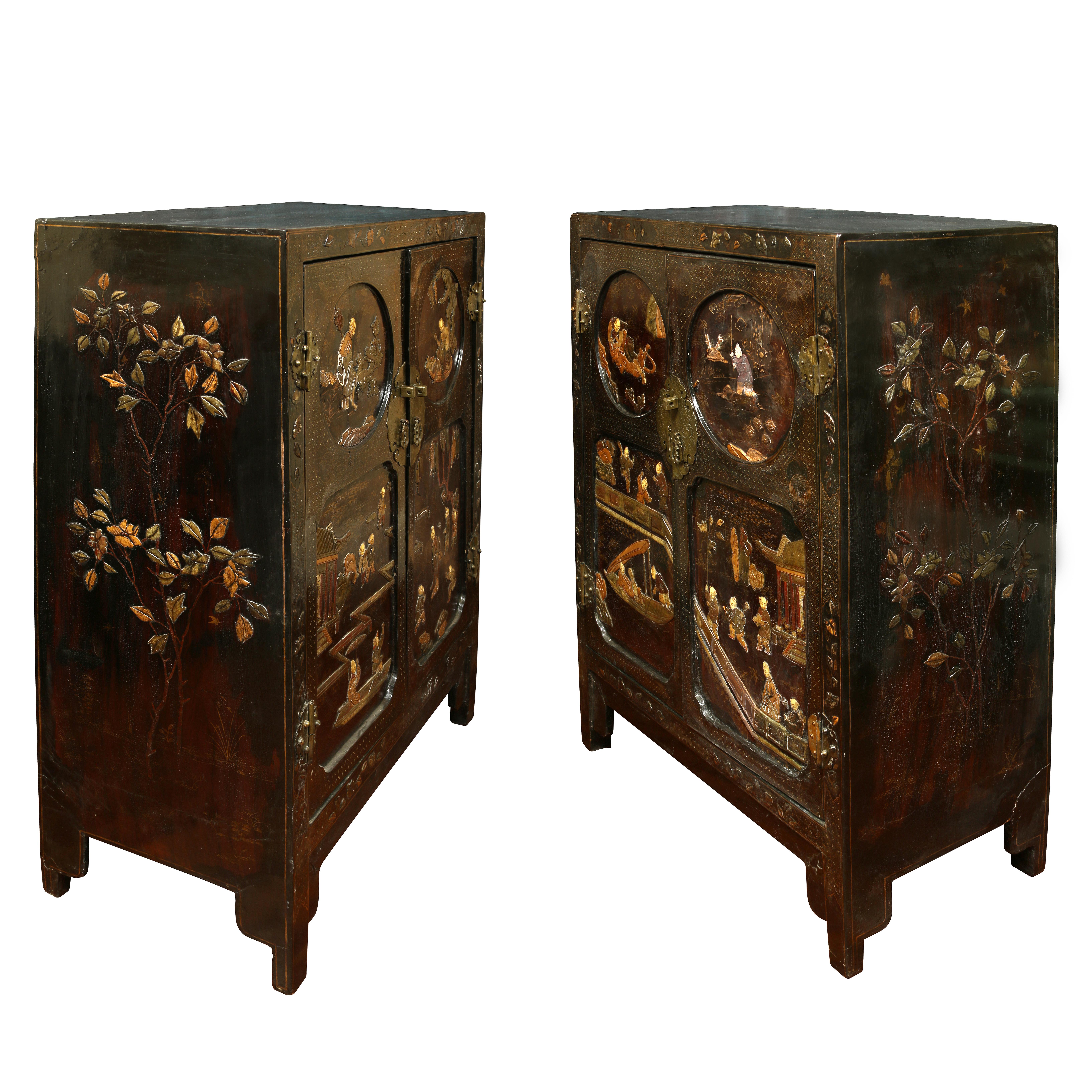 A very special pair of Asian Coromandel cabinets. Each cabinet has two doors with scenic figural inset panel.