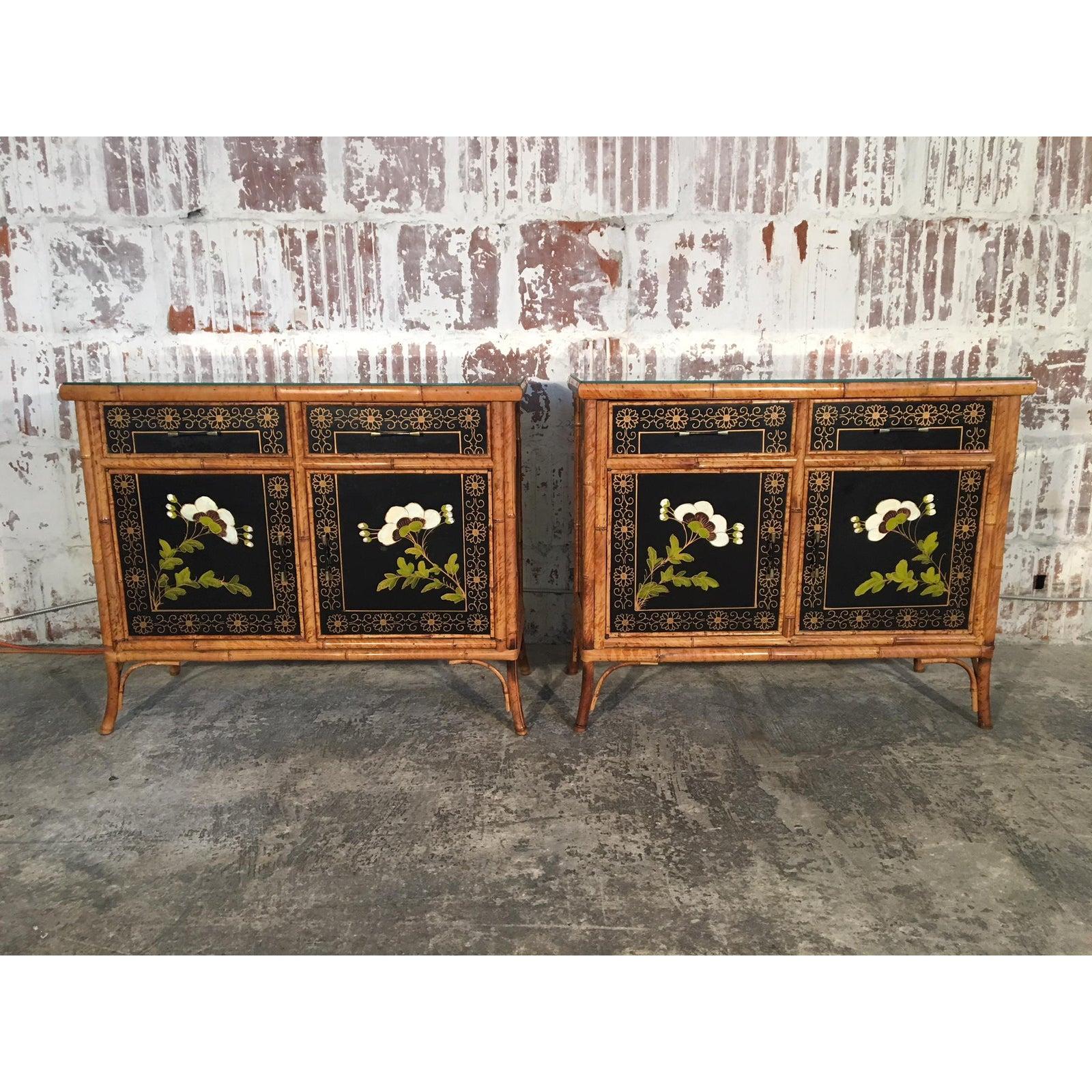 Twin Asian chinoiserie cabinets feature hand painted floral scenes and bamboo detailing. Dovetail joints, glass tops and brass hardware. Very good vintage condition with minor signs of age appropriate wear. One small chip on back corner of one glass