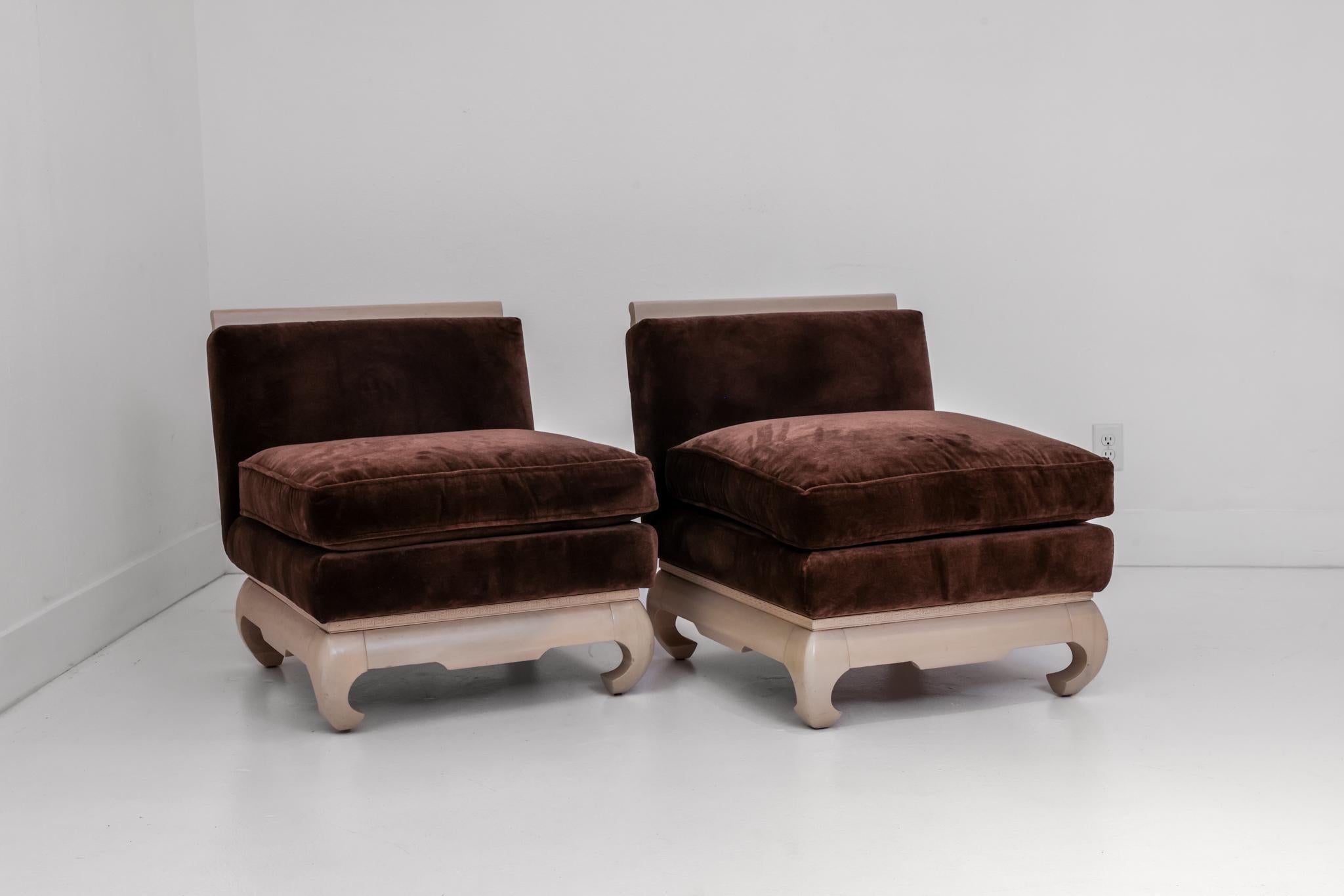 This is an exceptionally well crafted pair of asian inspired slipper chairs, newly upholstered in a cashmere velvet with bleached wood accents. Circa 1940s, these chairs reflect the asian influence seen in design in the U.S. during the midcentury