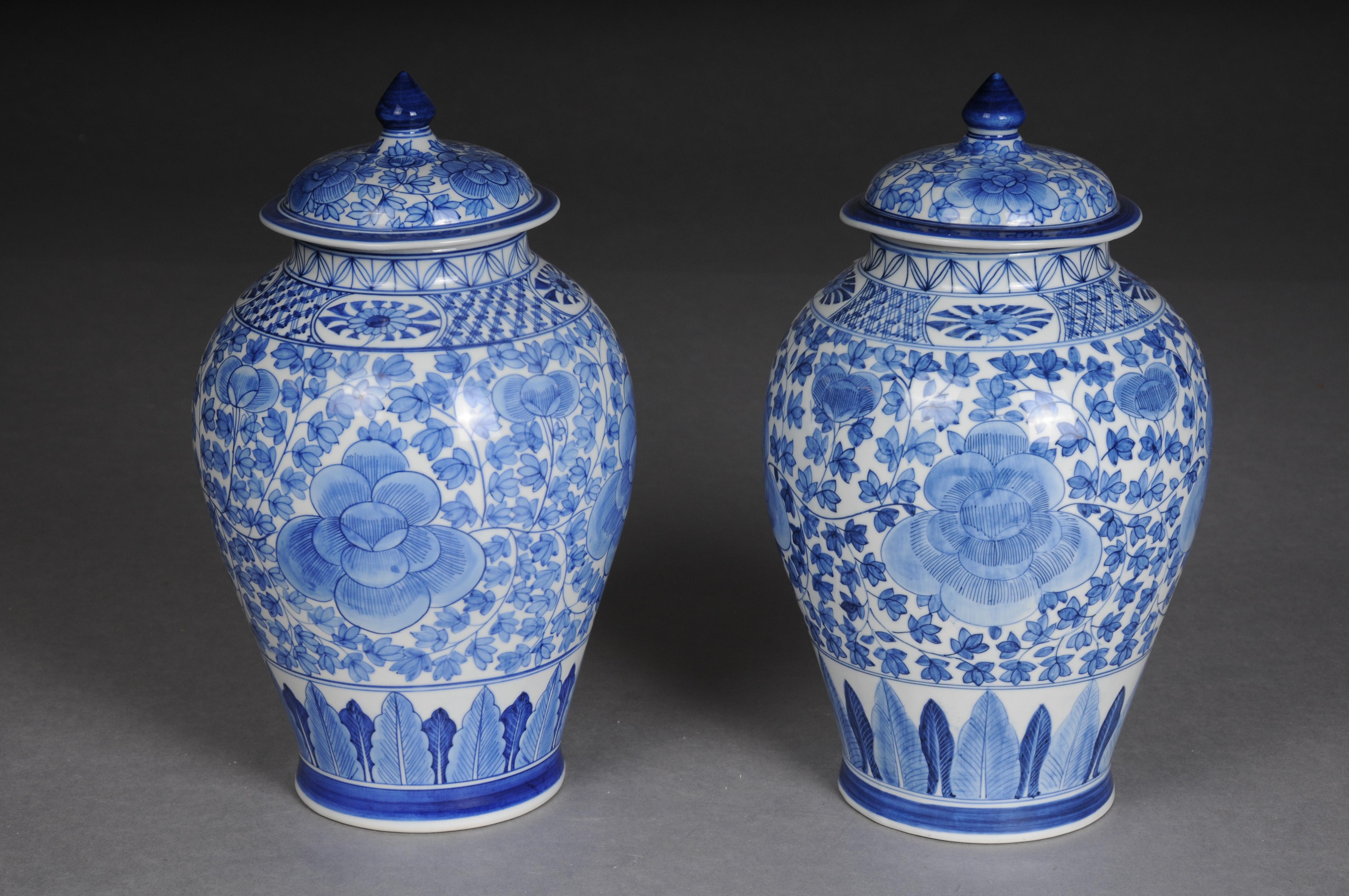 Pair of Asian lidded vases, porcelain, 20th century.

Porcelain, blue painting with Asian design. Bulbous body with a curved lid crowned with a pointed knob.
A very beautiful pair with a lot of charm and style. Very decorative and suitable for any