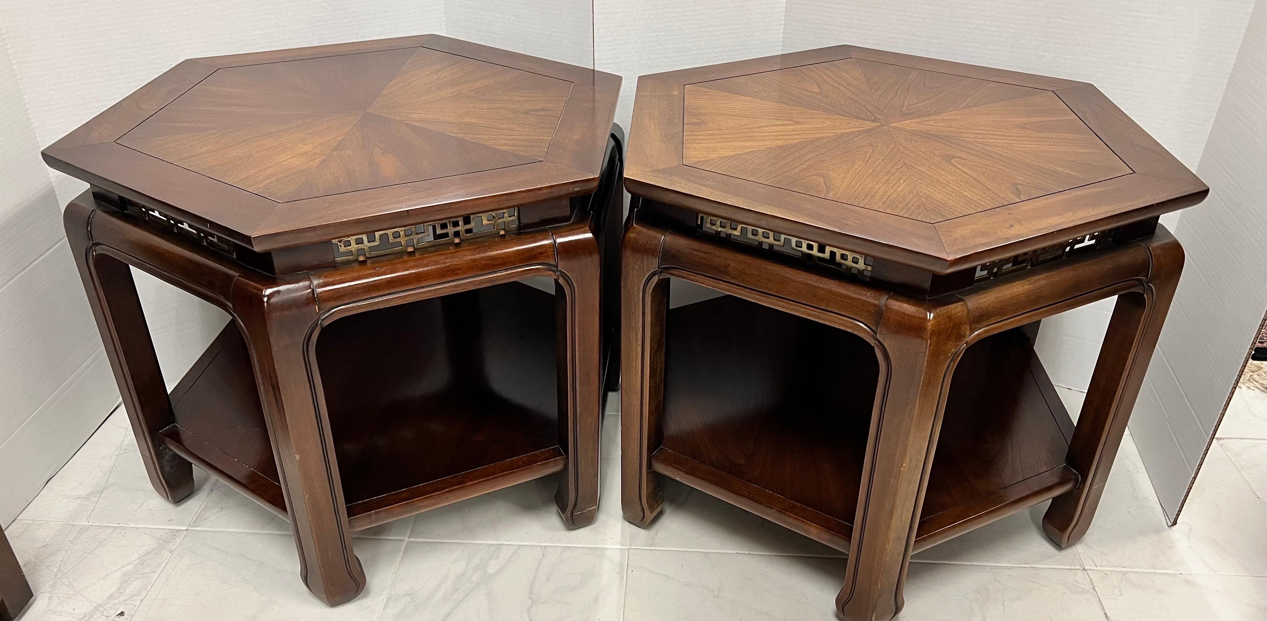Pair of matching mid century Chinoiserie style octagonal tables with bottom shelving as well and pierced brass accents and pie crust marquetry at top.
Why not own the best?