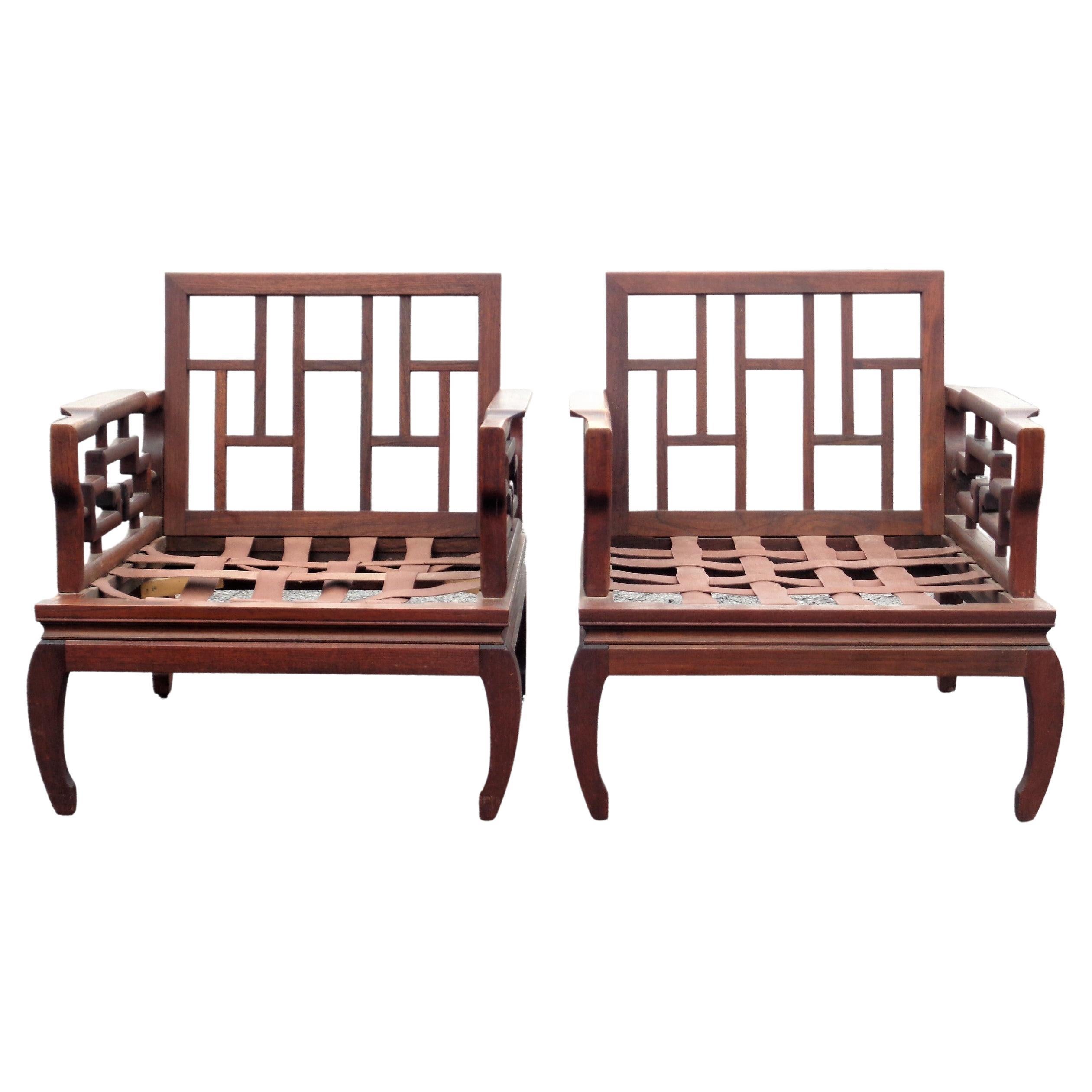A very elegant pair of Asian Ming style hand carved mahogany hardwood lounge chairs in nicely aged original surface color w/ beautifully figured grain. Exceptional quality finely detailed hand crafted woodwork w/ pegged joinery construction. These