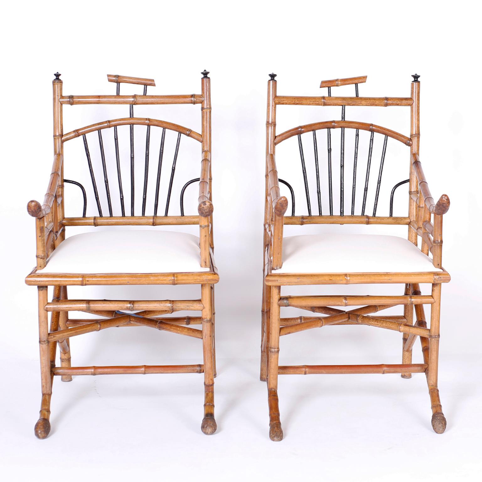 Unusual pair of Asian modern armchairs with Japanese influence crafted in bamboo and featuring bent and ebonized bamboo with roots on the arms and front feet.